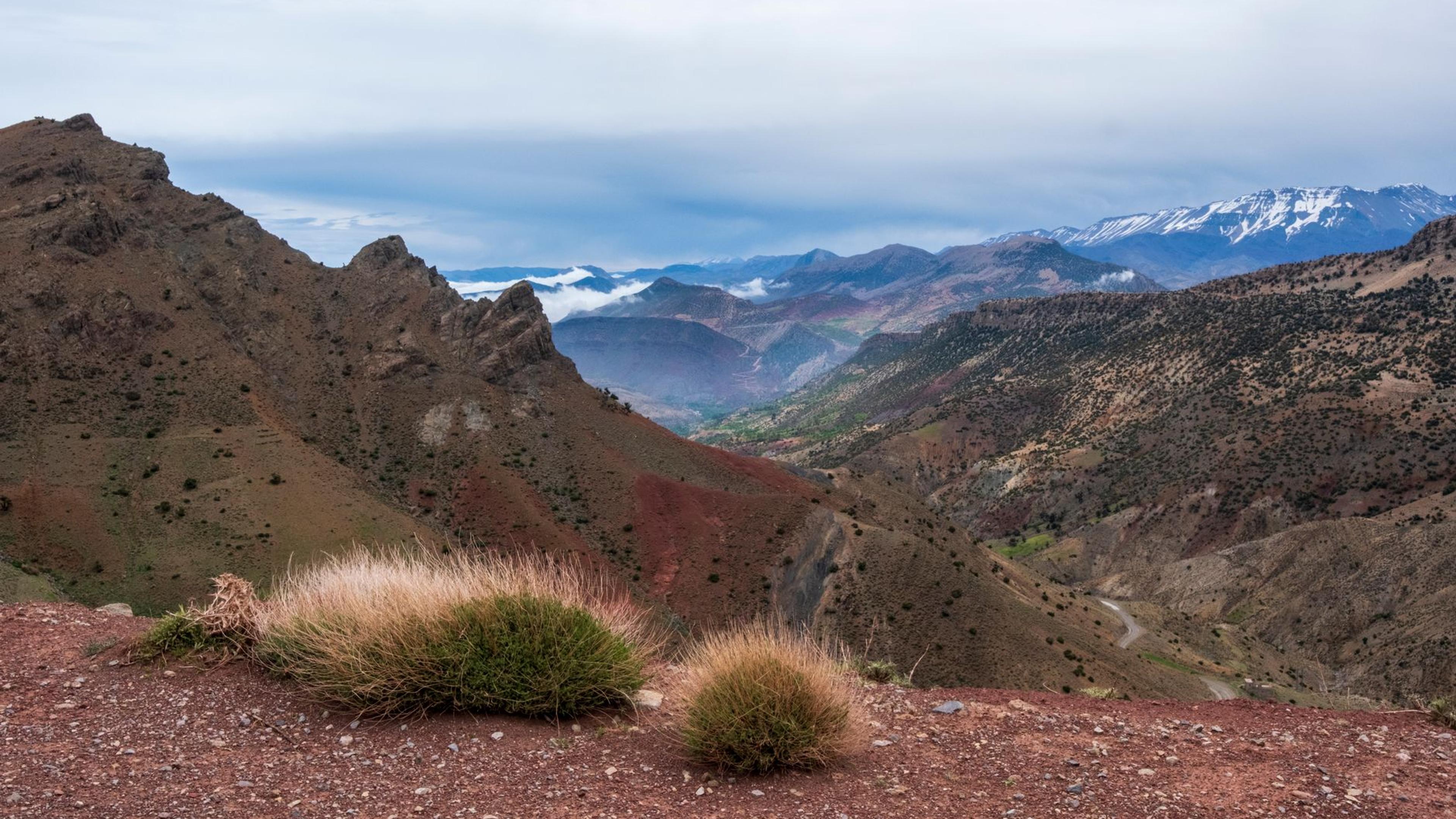 Scenic view of the Atlas Mountains in Morocco with rugged terrain and vast skies.