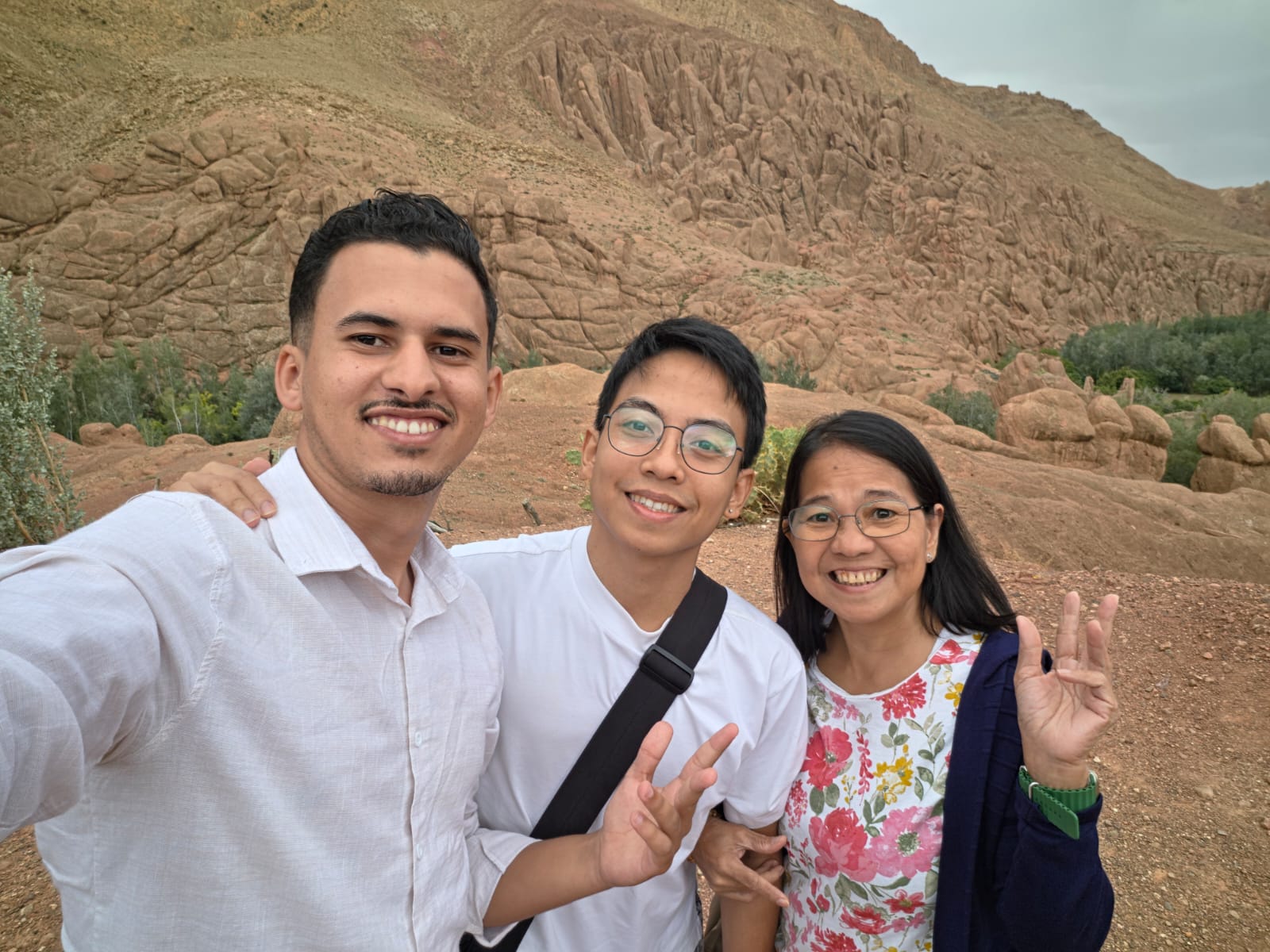 Moha from AZA Morocco Tours with two guests in front of the Monkey Fingers rock formations, Dades Valley