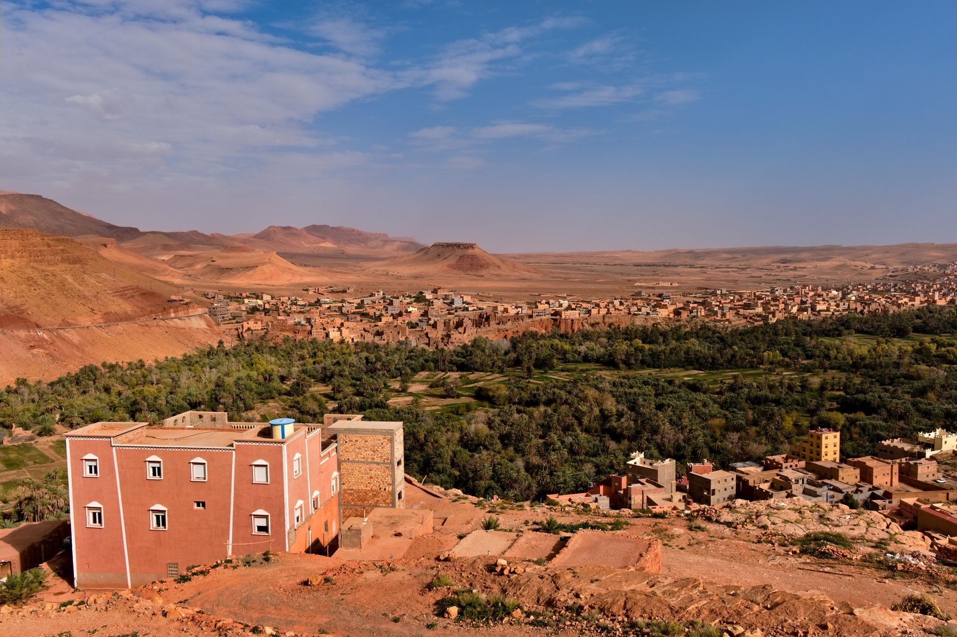 Vast Moroccan village landscape with picturesque buildings and desert scenery under a clear blue sky.