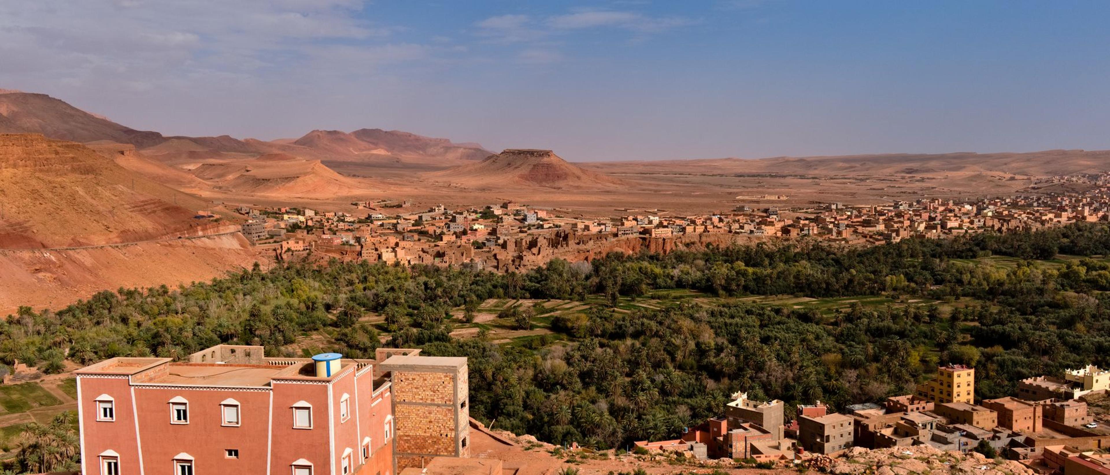 Vast Moroccan village landscape with picturesque buildings and desert scenery under a clear blue sky.