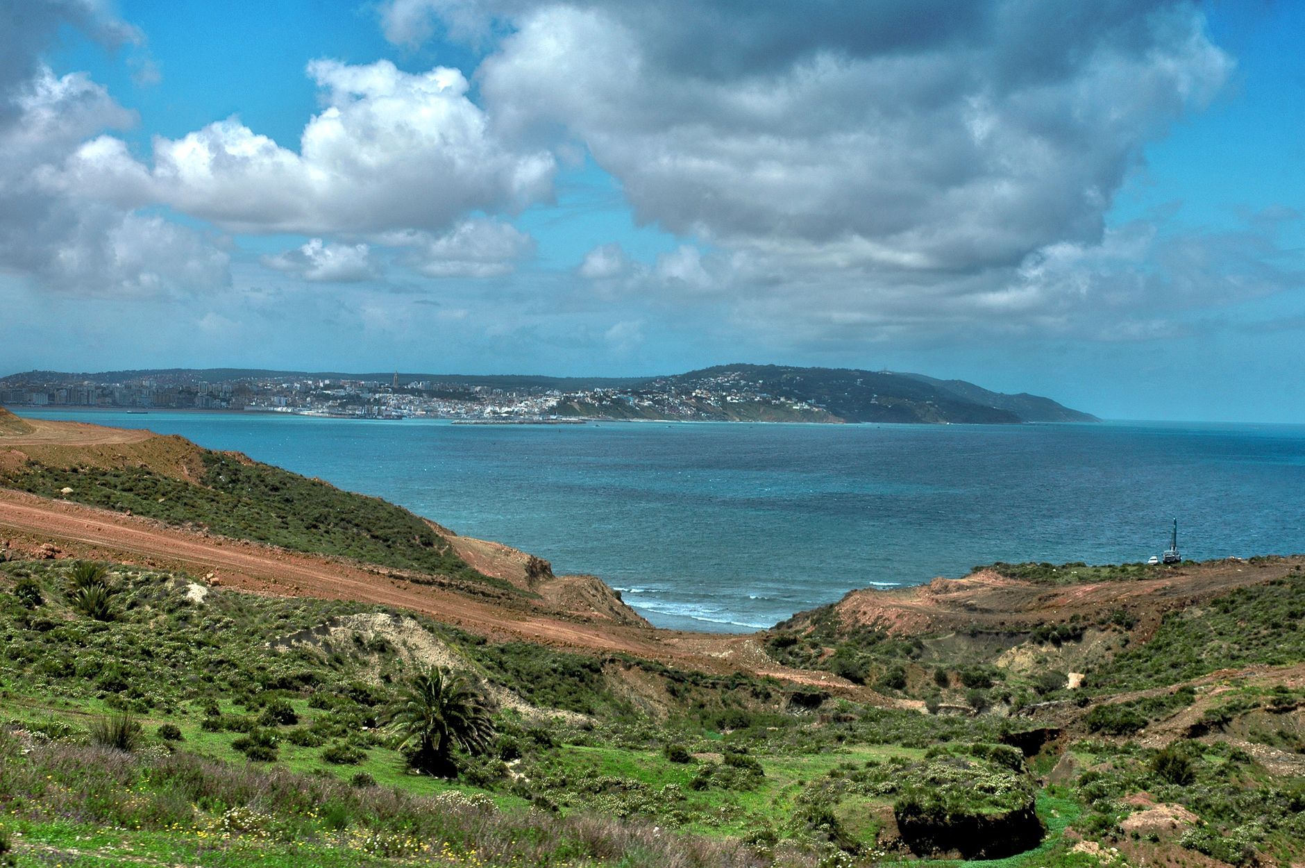 Stunning coastal landscape of Tangier, Morocco with lush greenery and blue sea.
