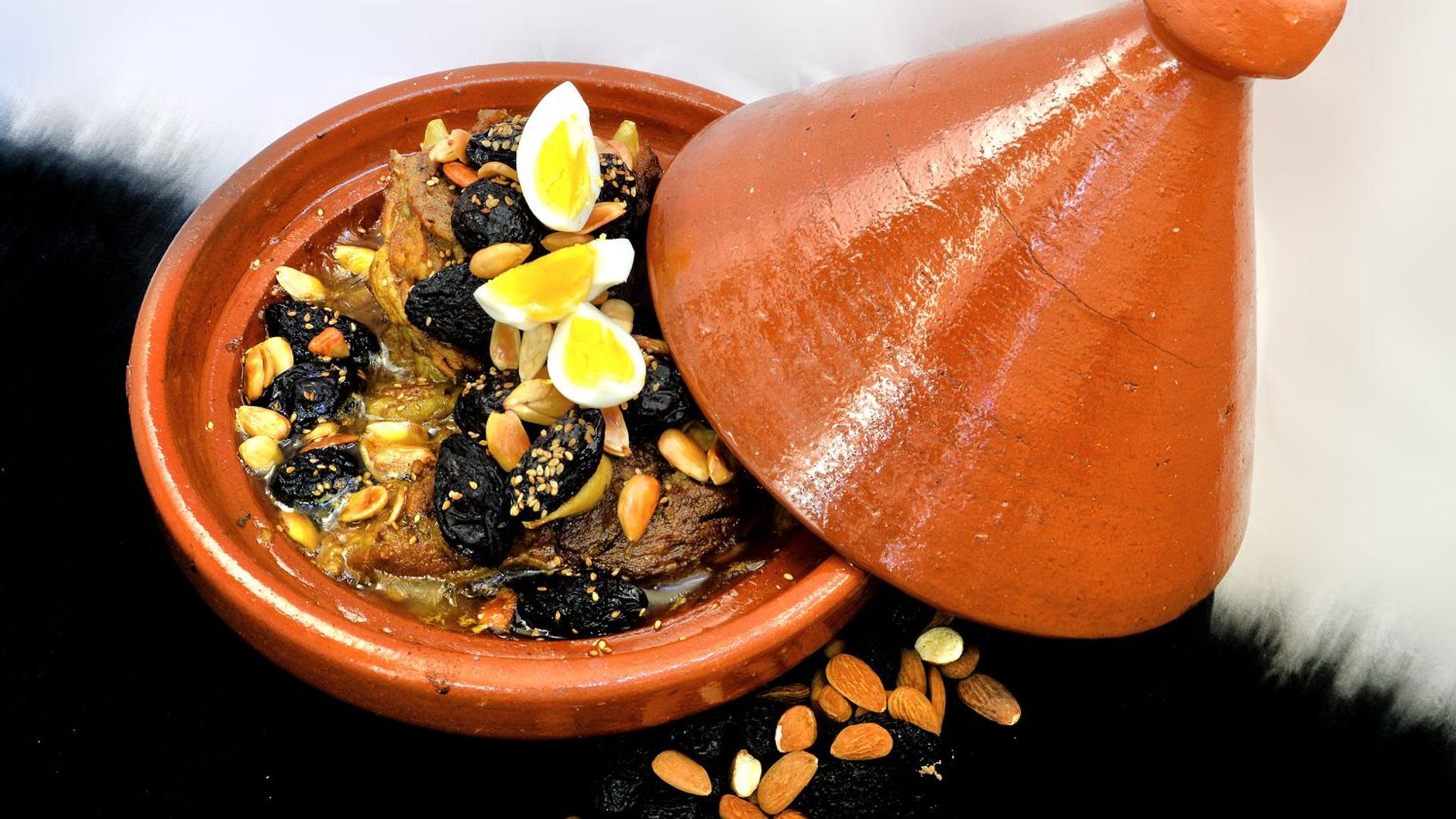 A traditional Moroccan tagine with meat, prunes, and almonds