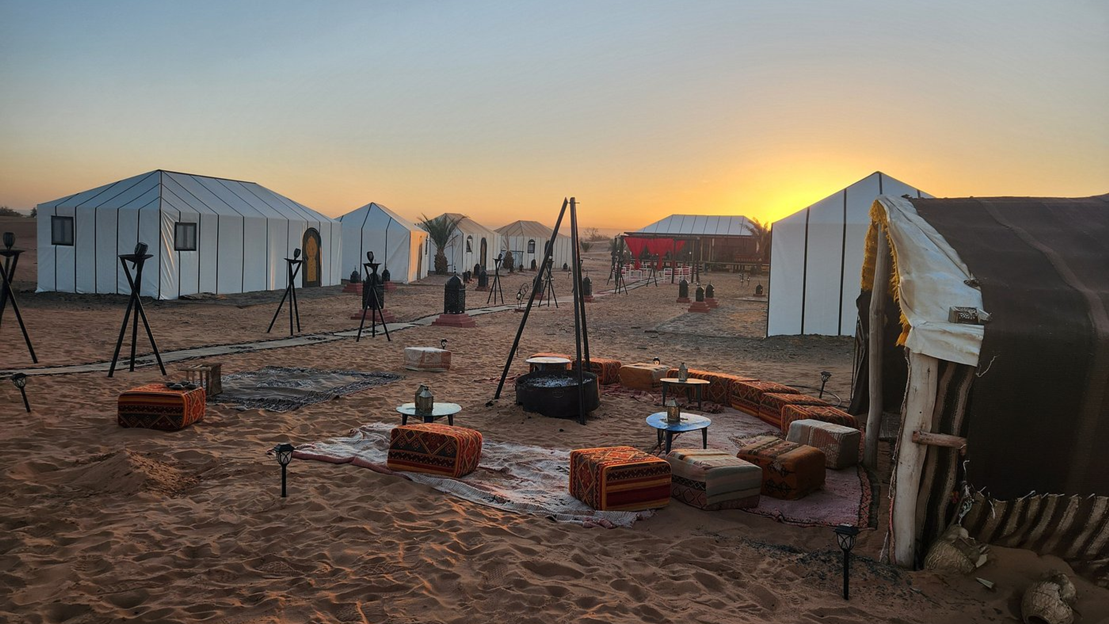 A desert camp of Berber tents in the Sahara at sunset