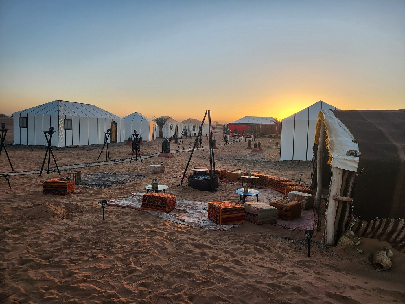 A desert camp of Berber tents in the Sahara at sunset