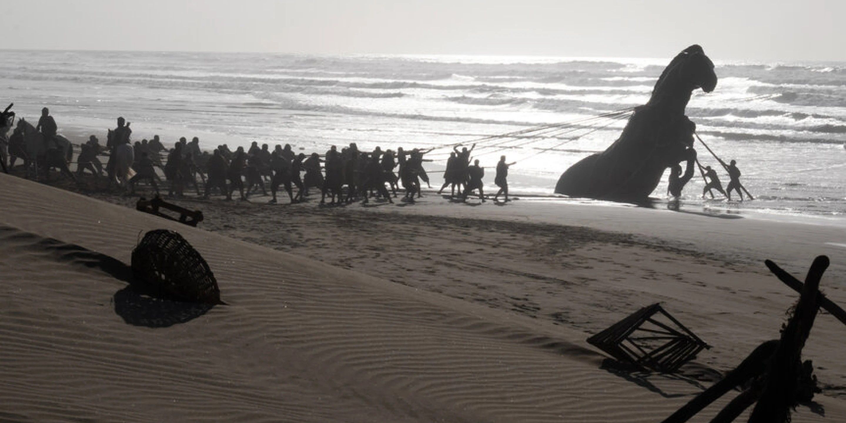 Behind-the-scenes photo of the Trojan Horse being pulled onto a Moroccan beach during filming of The Odyssey