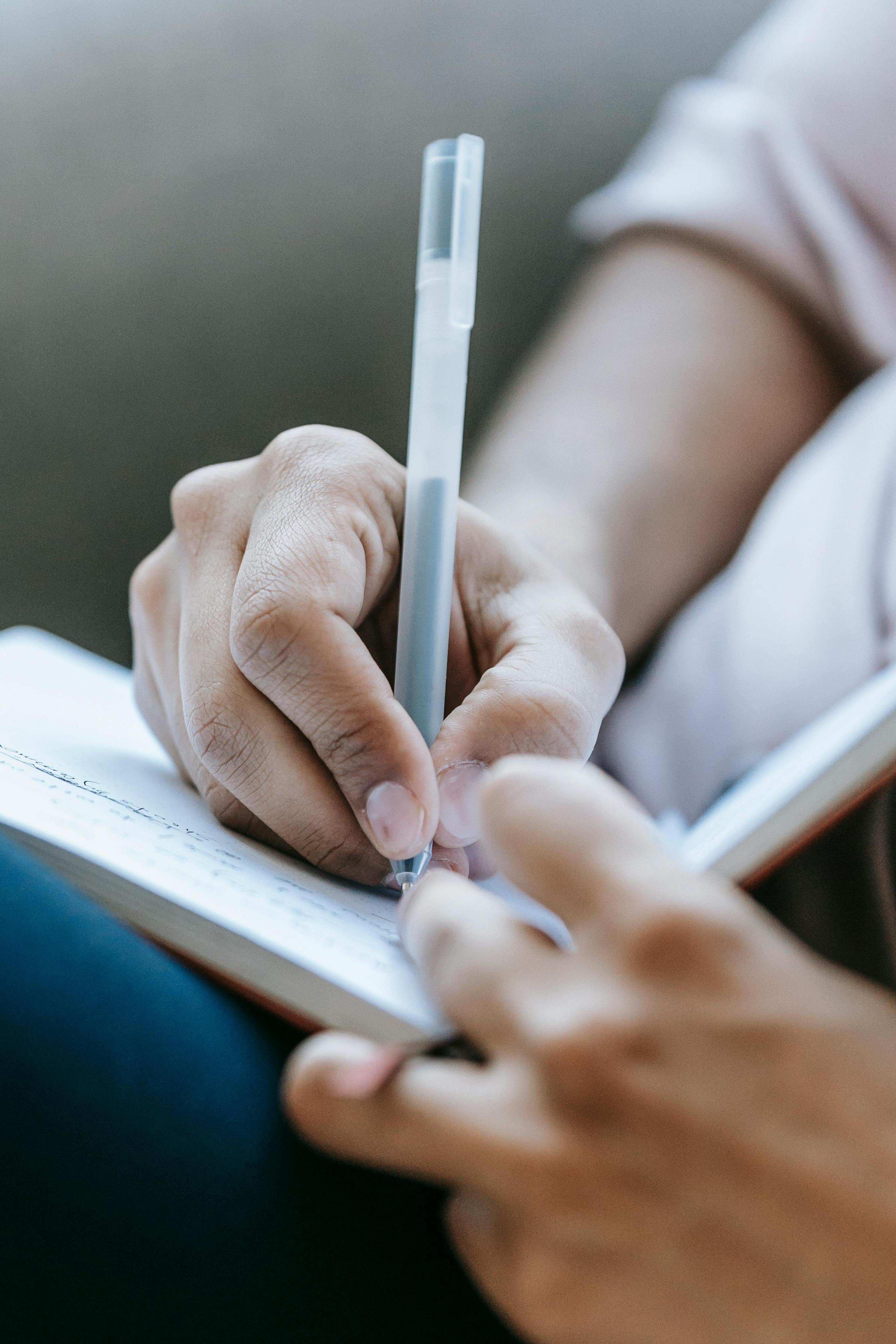 A woman writing in a gratitude journal, focused on her relationship.