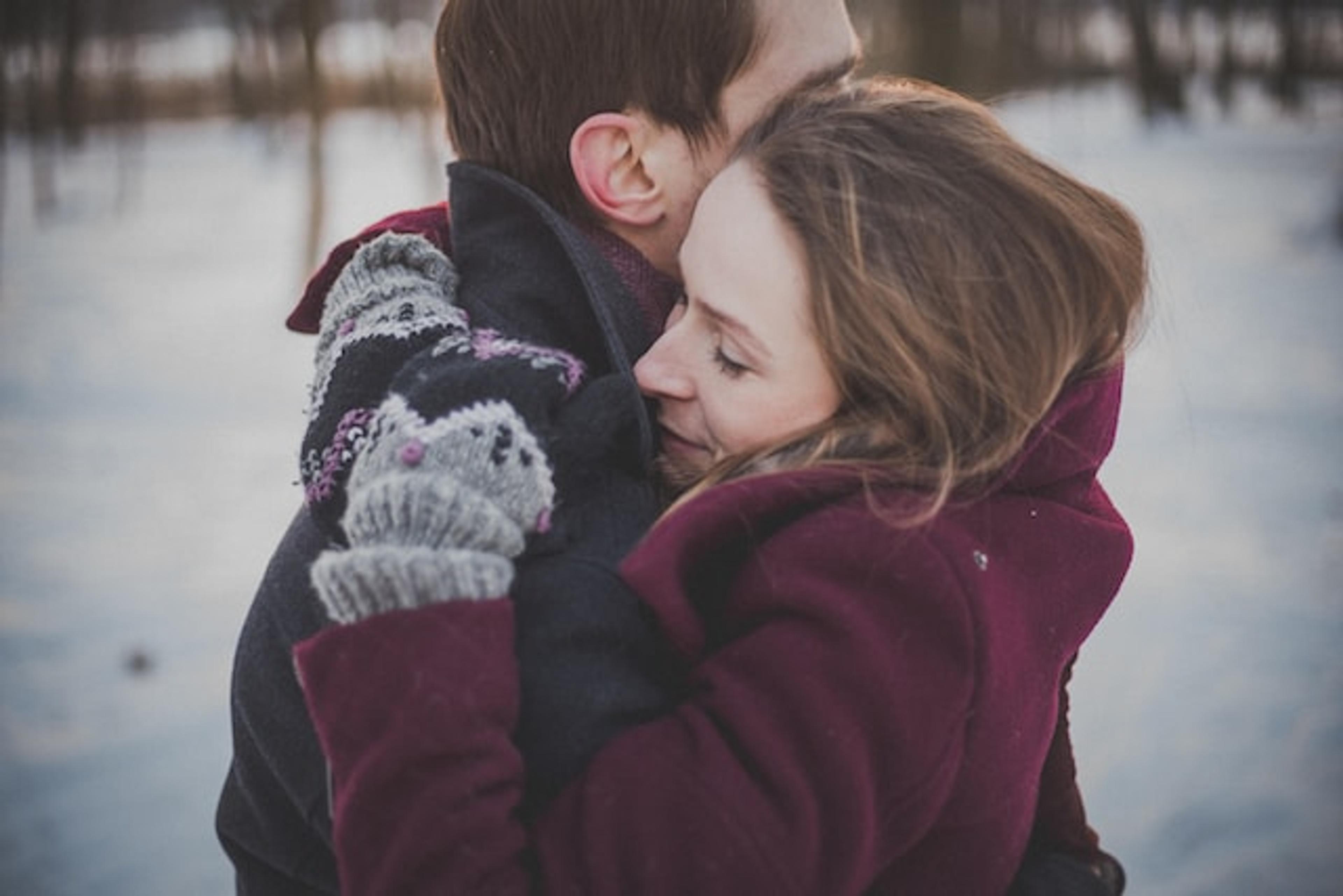 A man and a woman hugging each other and wondering how to improve their relationship