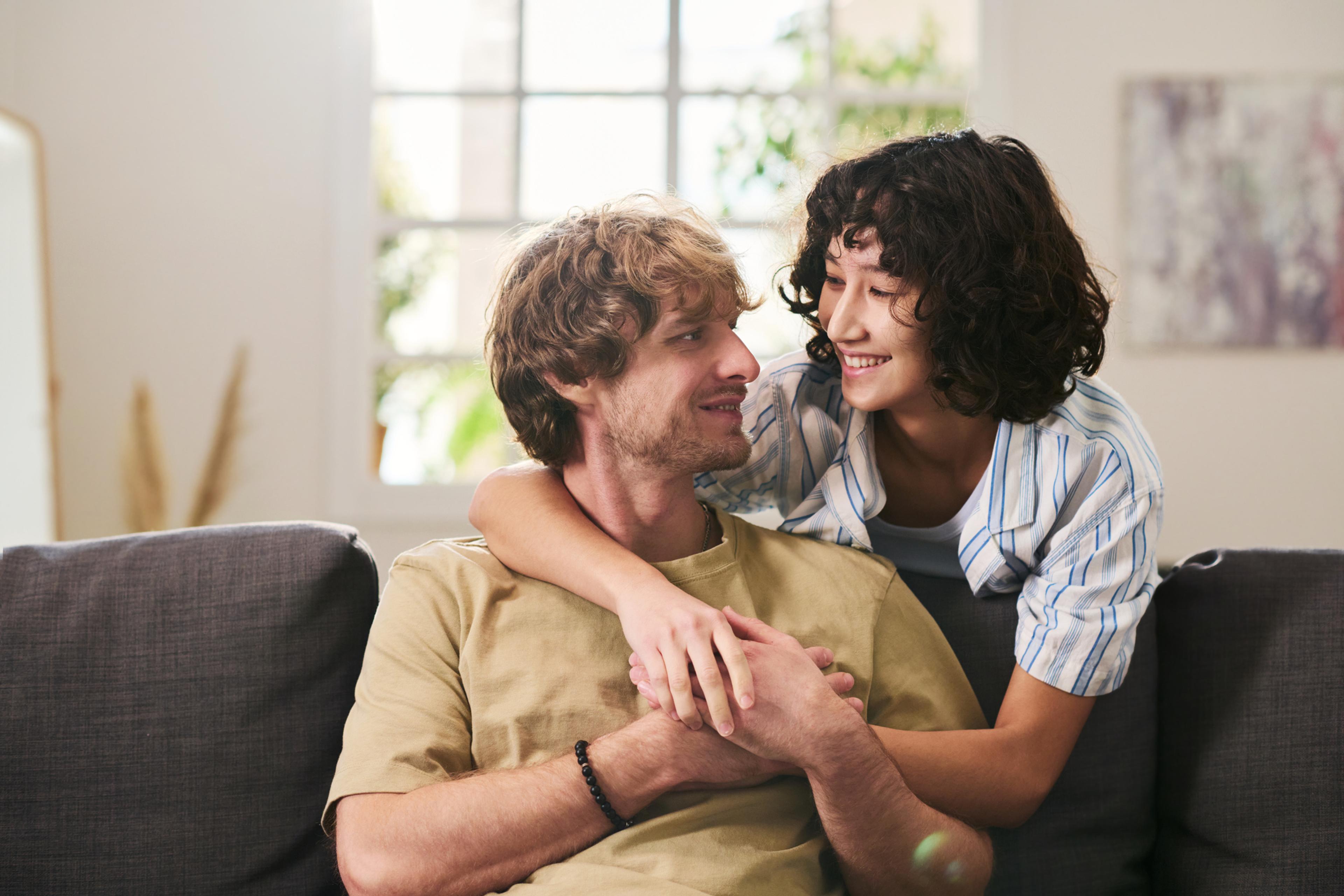 A man and woman sitting on a couch 