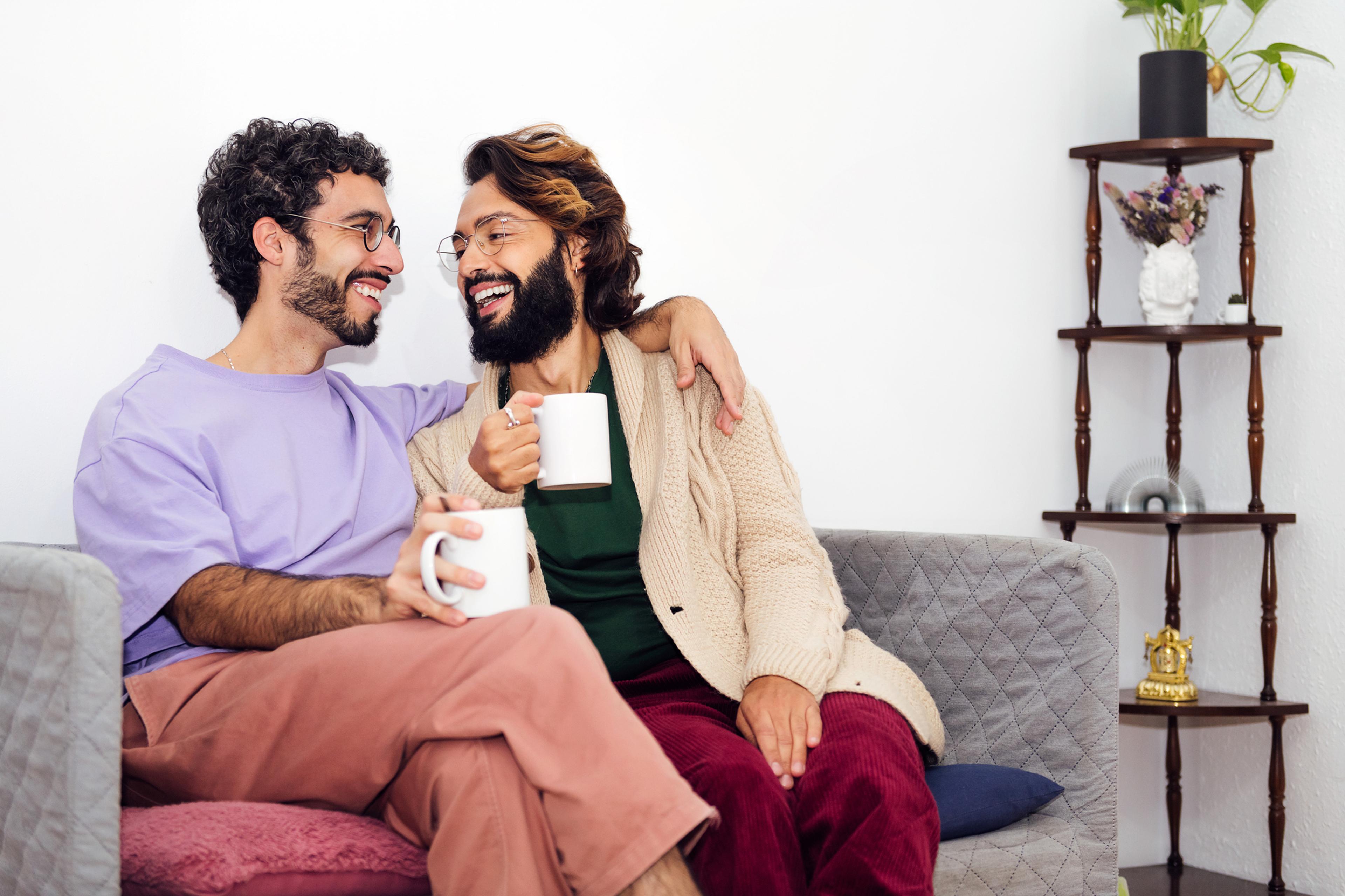two men sitting in a couch and discussing the seven principles for making marriage work
