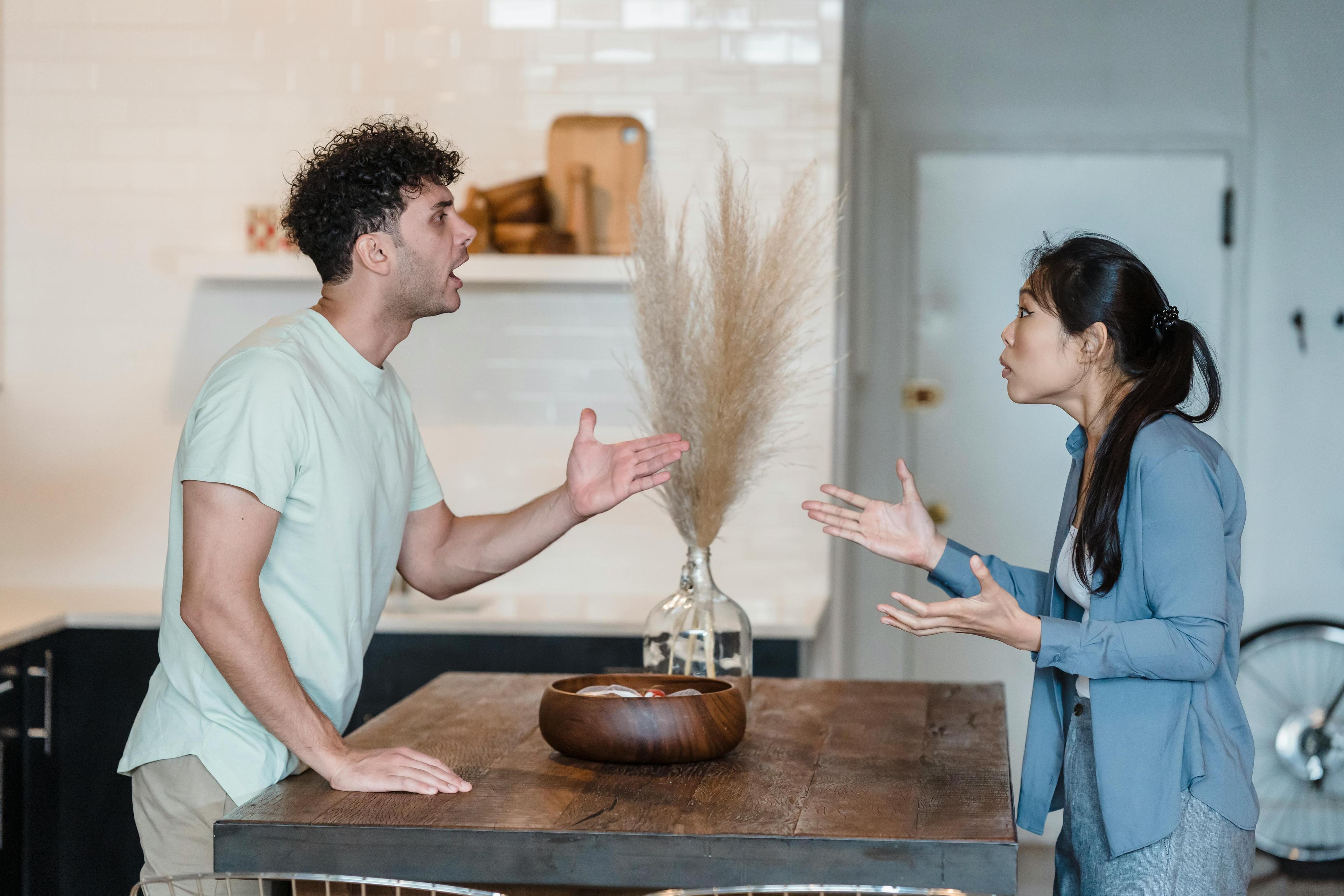 A man and woman discussing in a kitchen. Symbolizes borderline personality disorder and relationships.