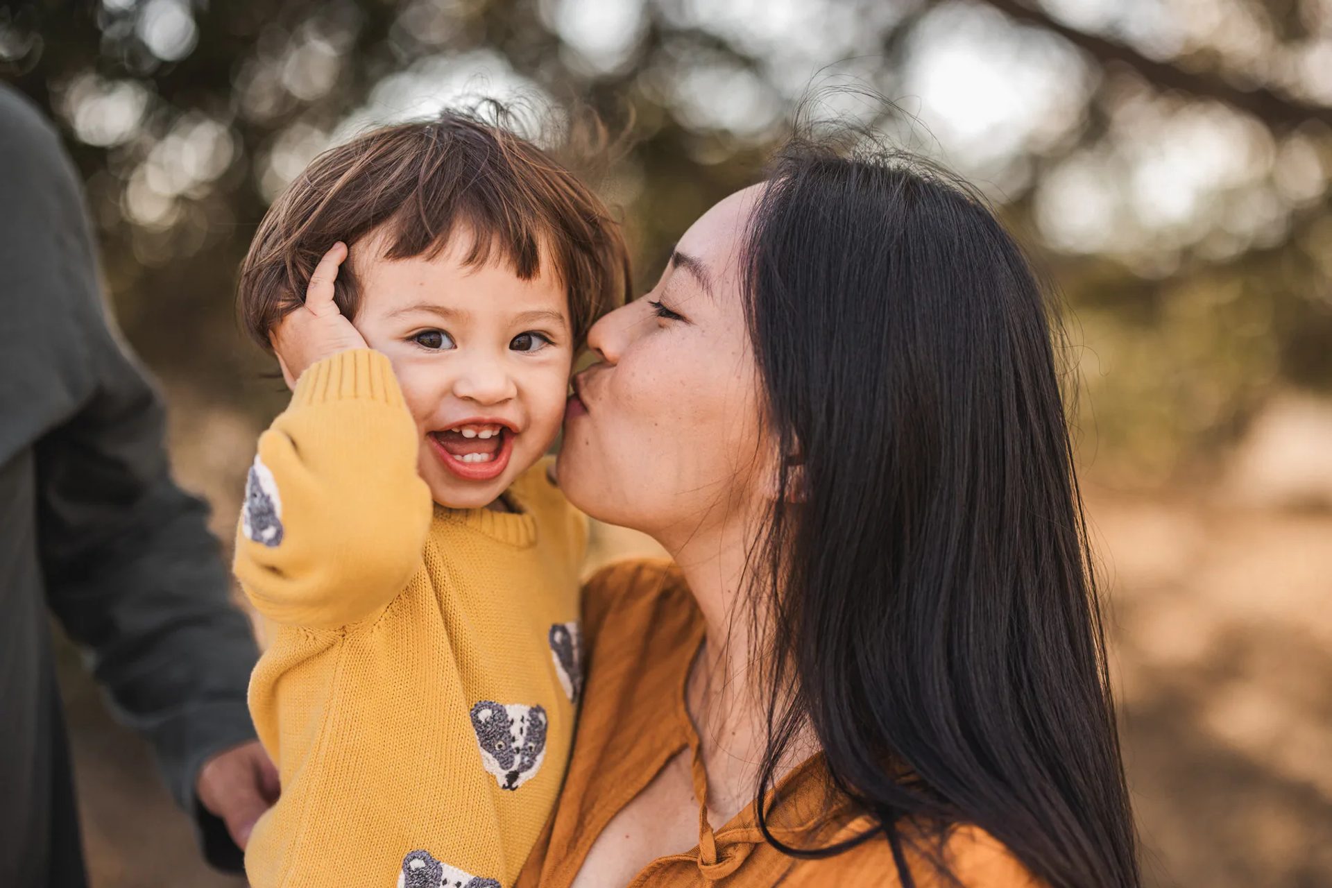 A mother and child sharing a joyful moment outdoors