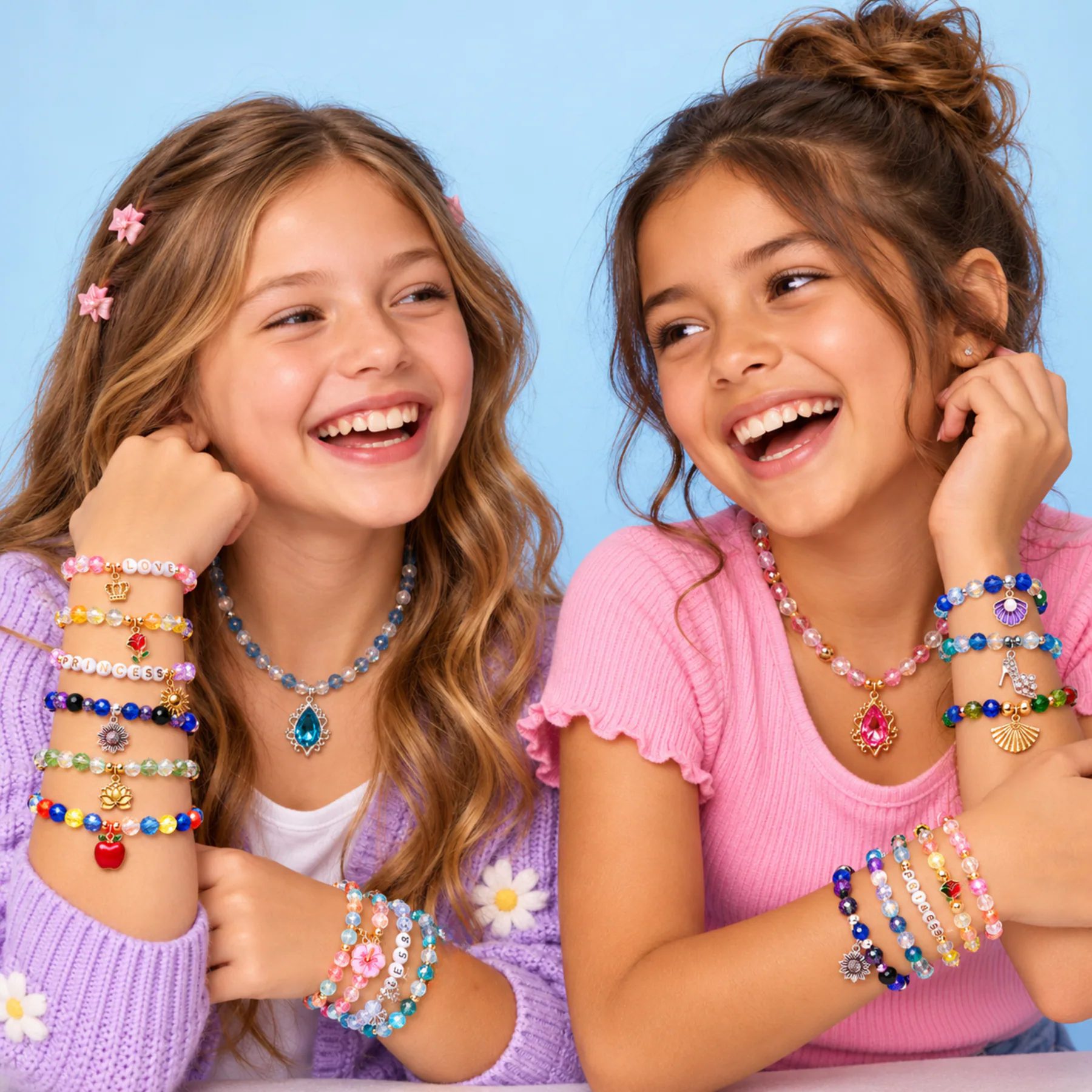 Two friends showing the colorful GALASET bracelets they created