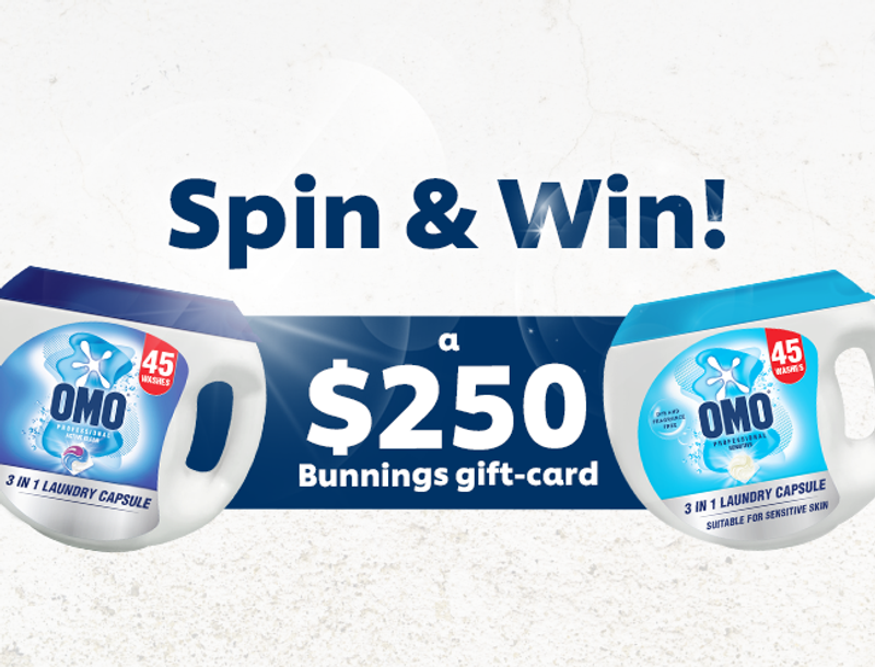 Advertisement for an OMO 'Spin & Win' contest featuring two OMO laundry capsule containers and promoting a $250 Bunnings gift card prize.