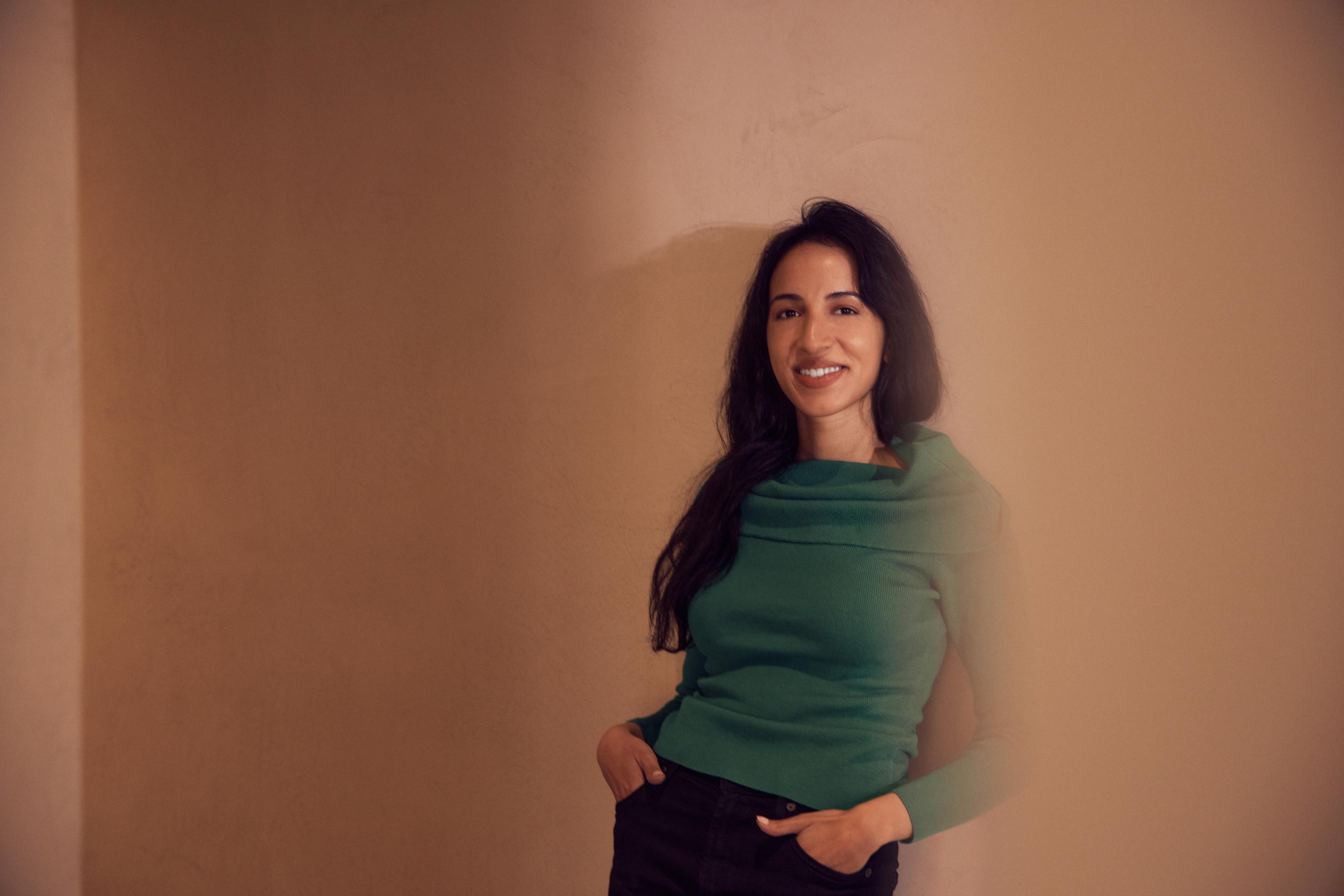 Photograph by Derek Yarra of Noor Siddiqui in a green sweater with her hands in pocket | Meridian by Mercury