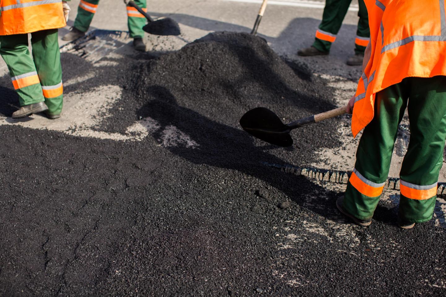 AAA Paving roller compacting fresh commercial asphalt