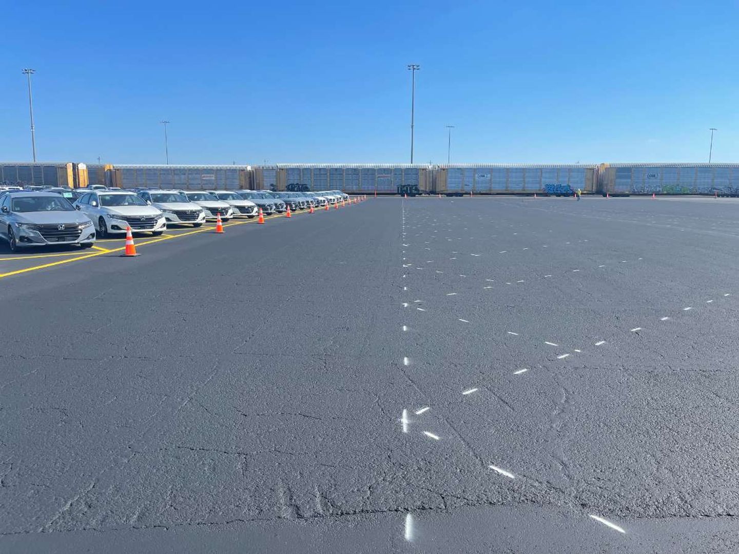 Freshly paved and striped commercial parking lot by AAA Paving