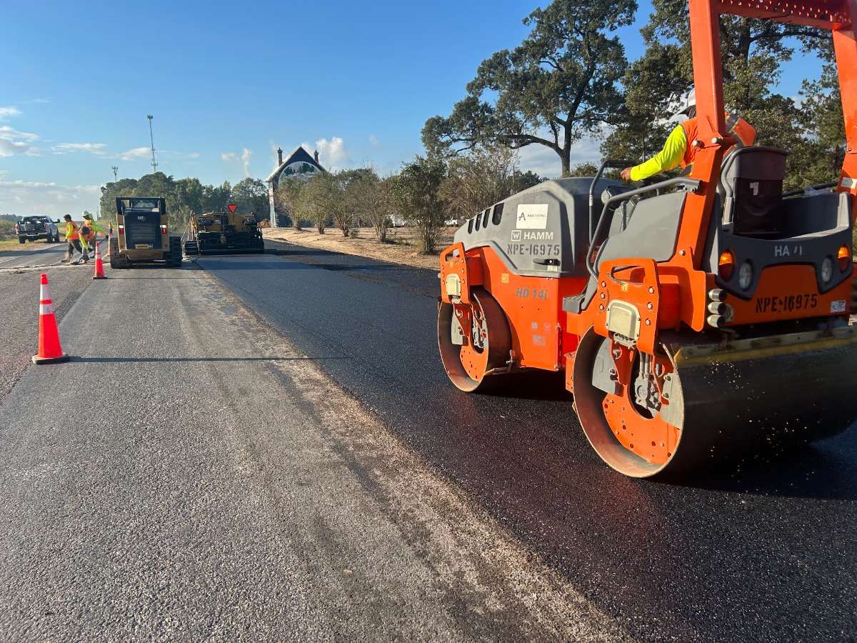 AAA Paving roller and crew compacting fresh asphalt on a commercial project
