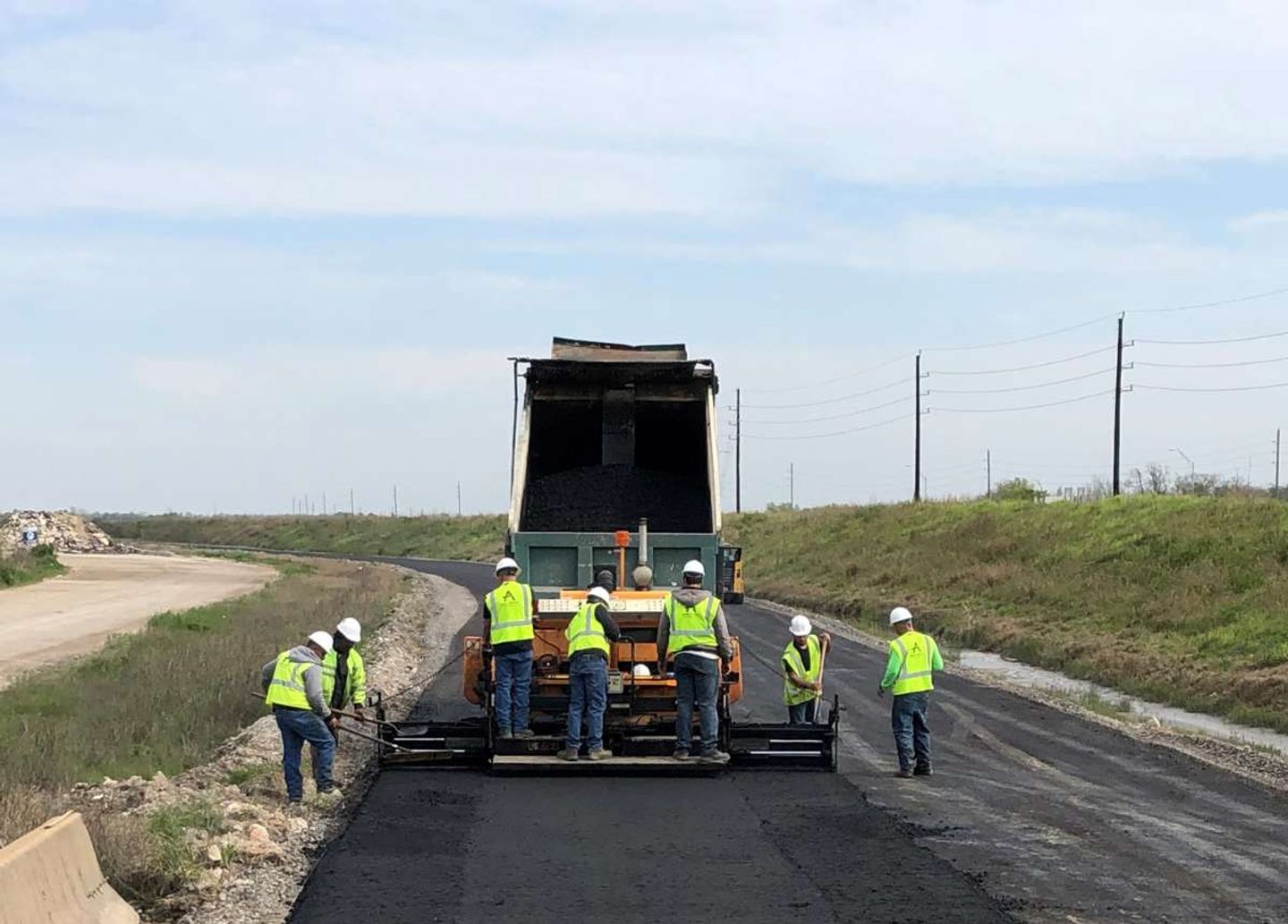 AAA Paving crew and paver at work on a Houston commercial paving project