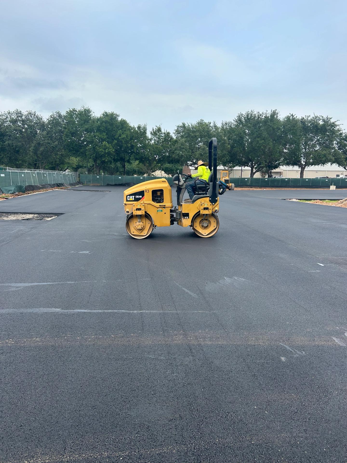 Aerial of a freshly paved and striped retail center parking lot completed by AAA Paving in the Houston area
