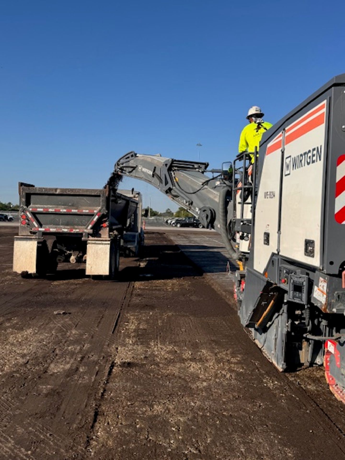 Cracked, failing commercial asphalt of the kind a cut-corner job leaves behind