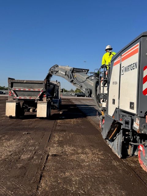 Cracked, failing commercial asphalt of the kind a cut-corner job leaves behind