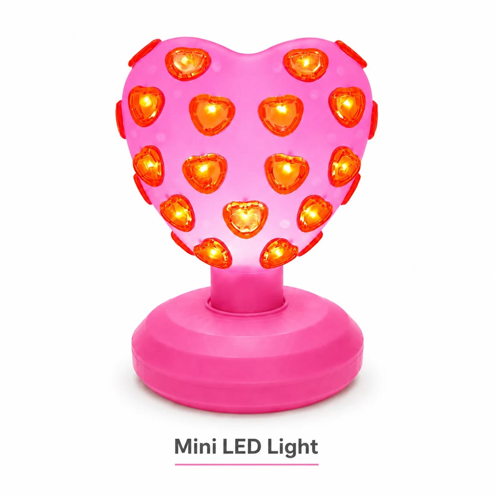 MX-6015H mini heart LED party light with pink ABS body and round base on a clean white background.