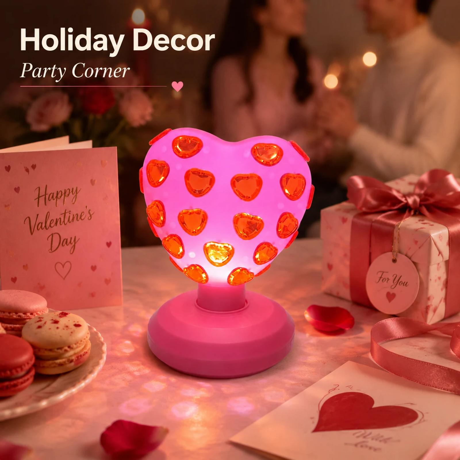 Pink heart disco light used as a Valentine gift and party table decoration in a warm holiday scene.