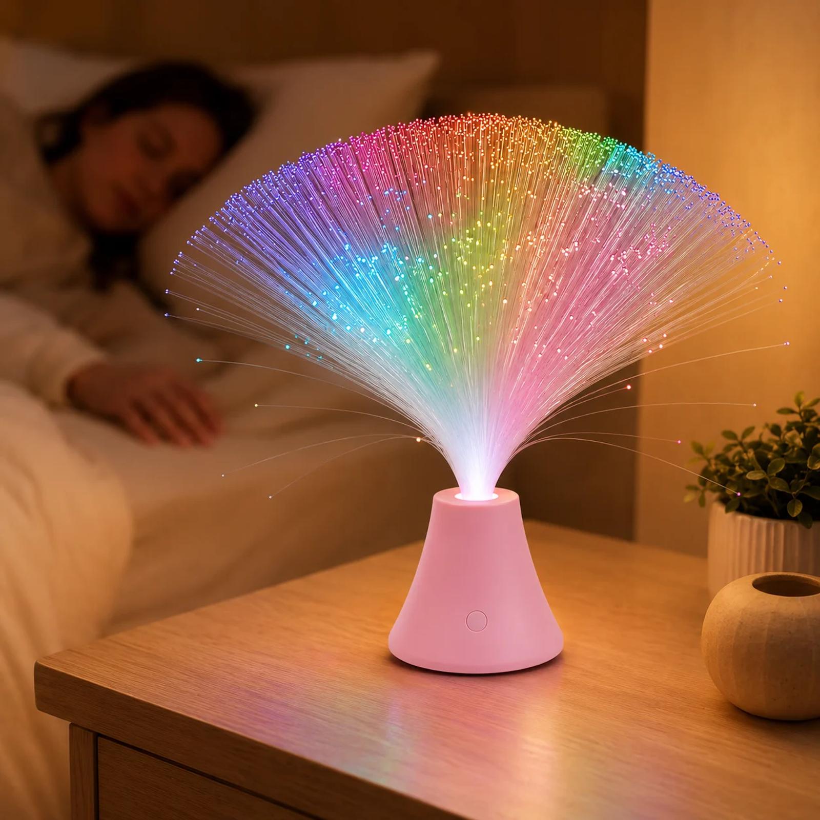 Pink touch color changing fiber optic lamp glowing on a bedside table in a soft lifestyle scene.