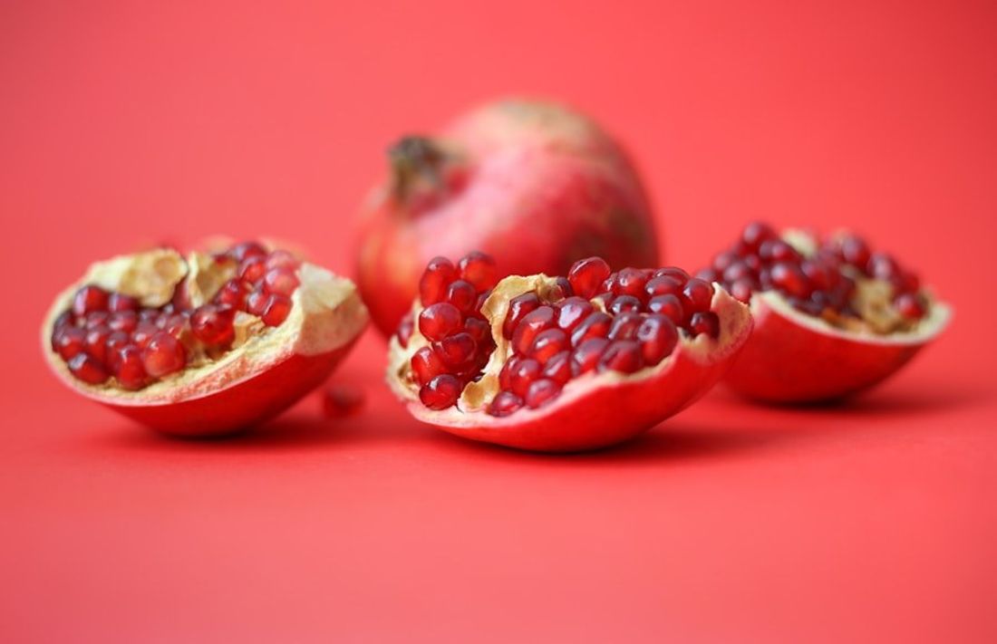 Fresh pomegranates, opened to show the seeds