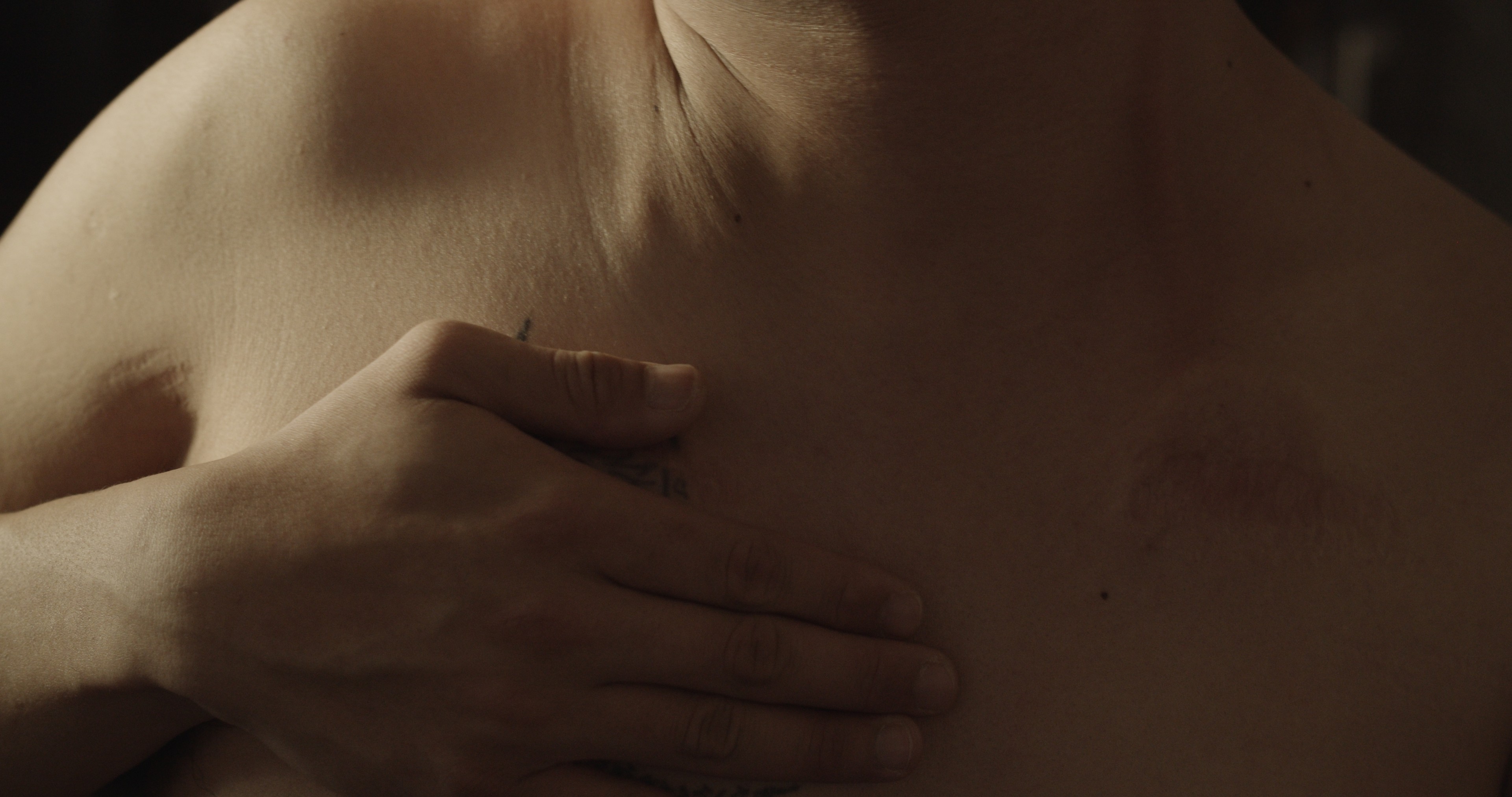 A hand laid on a chest.