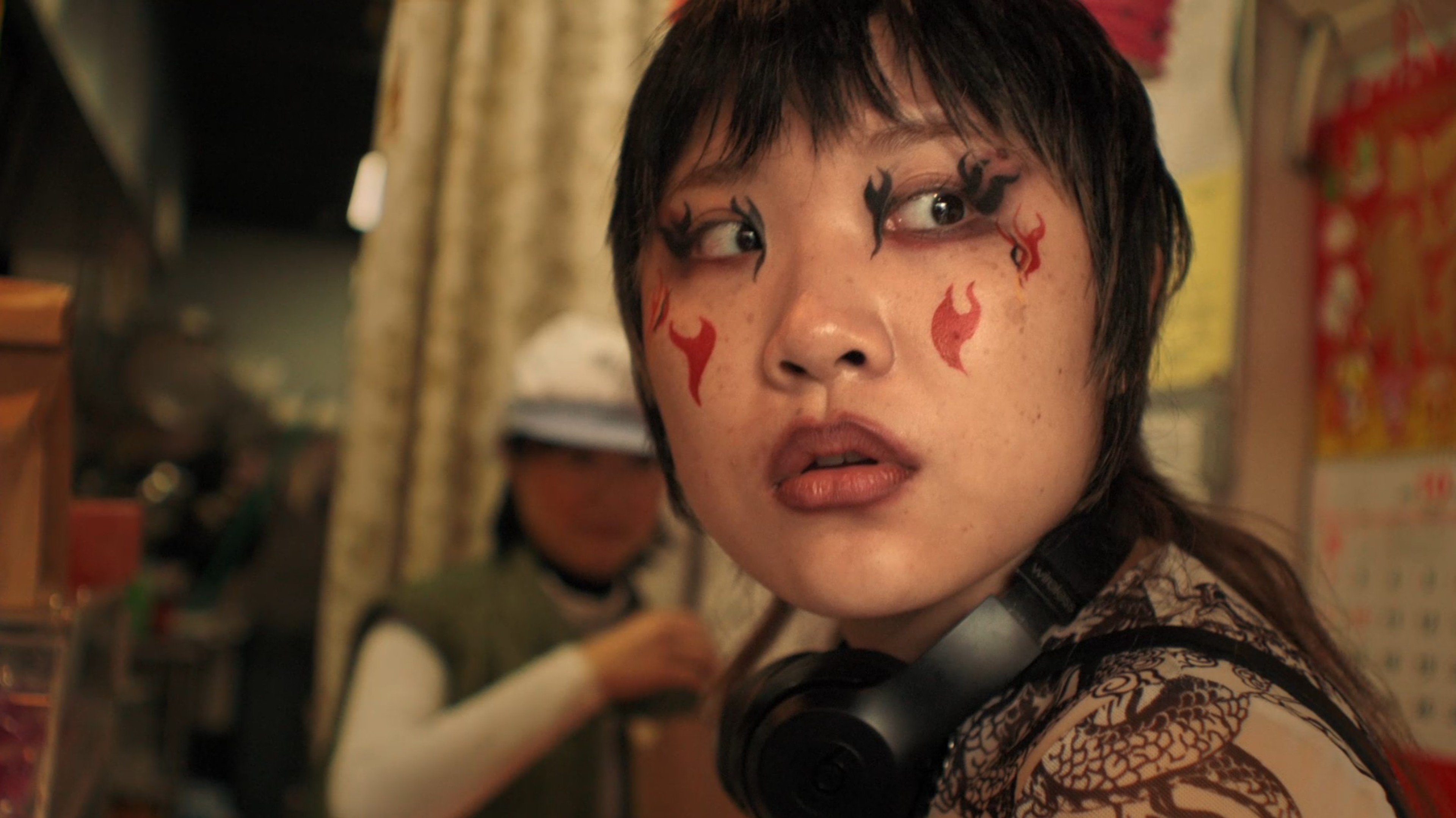 a person with red flames drawn onto their face.