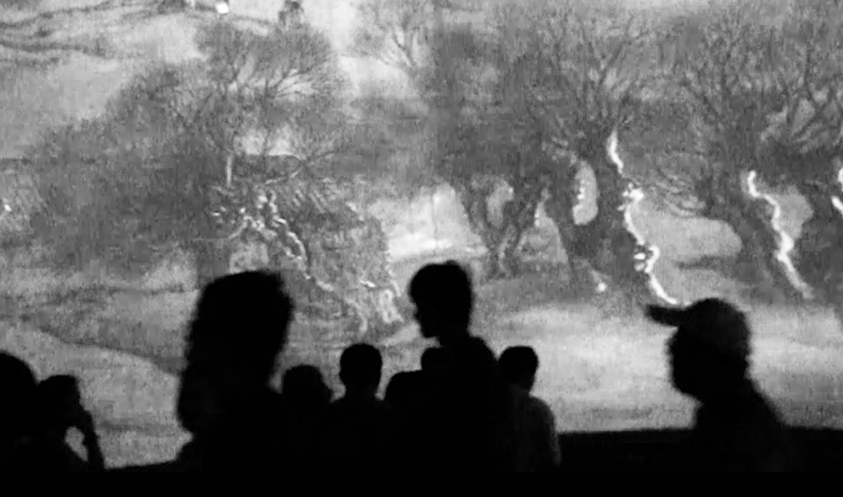Silhouettes of people against a photo of trees.