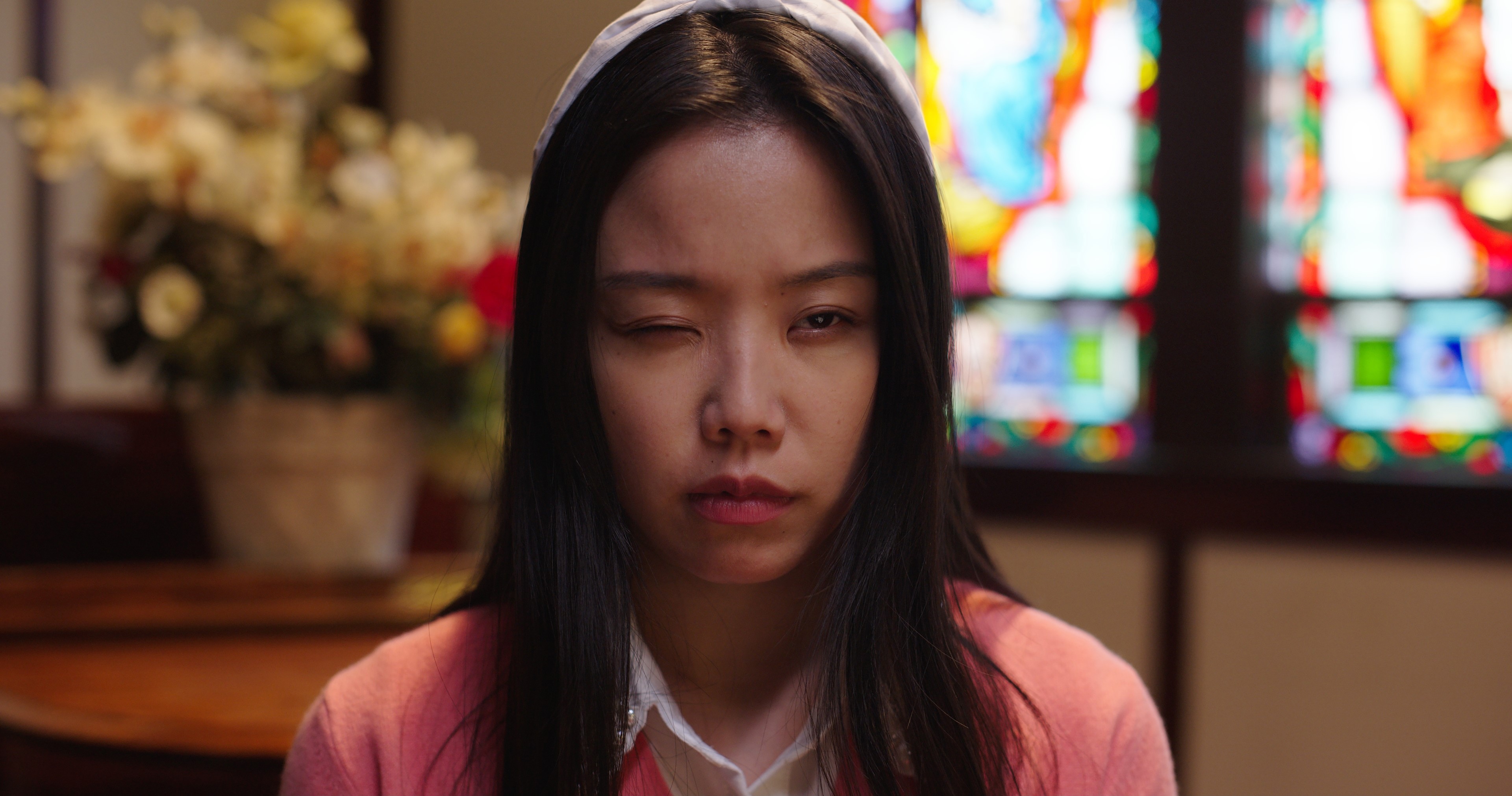 a girl with one eye closed.