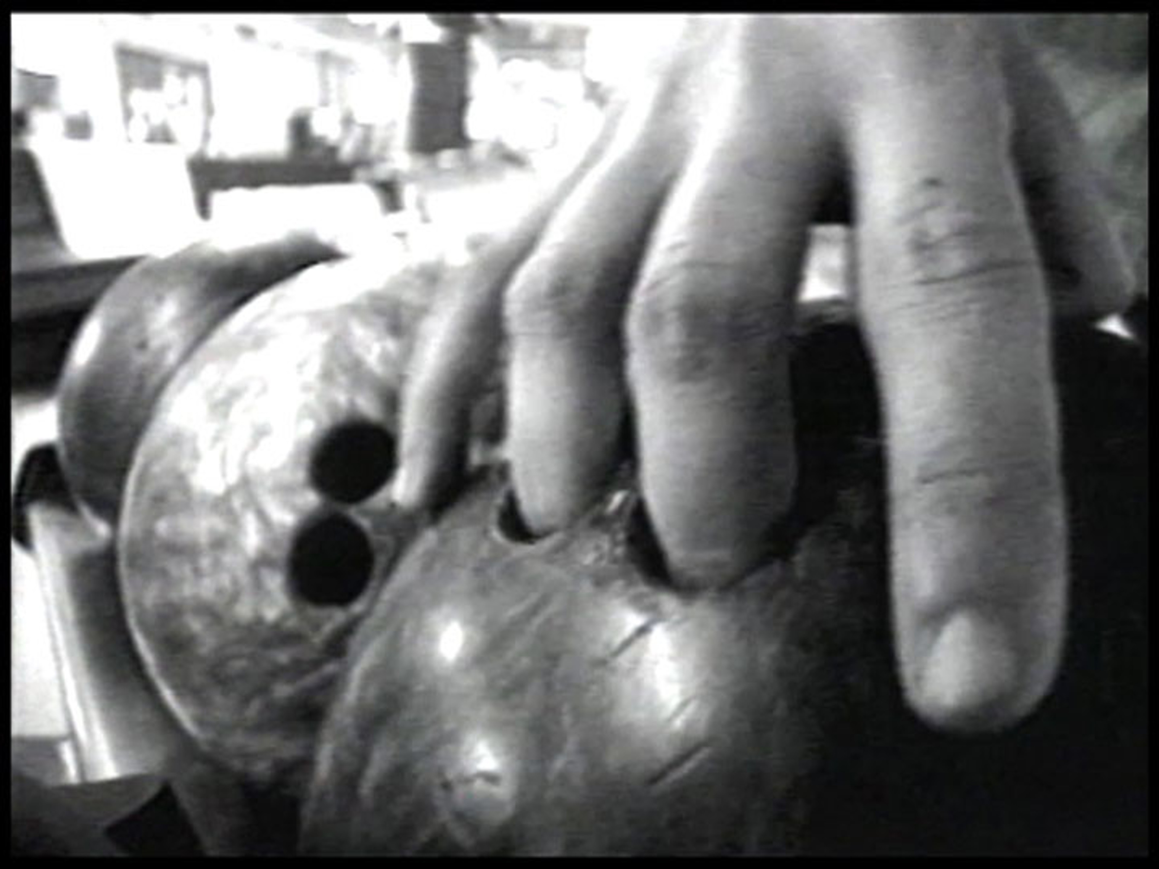 fingers inside the holes of a bowling ball.