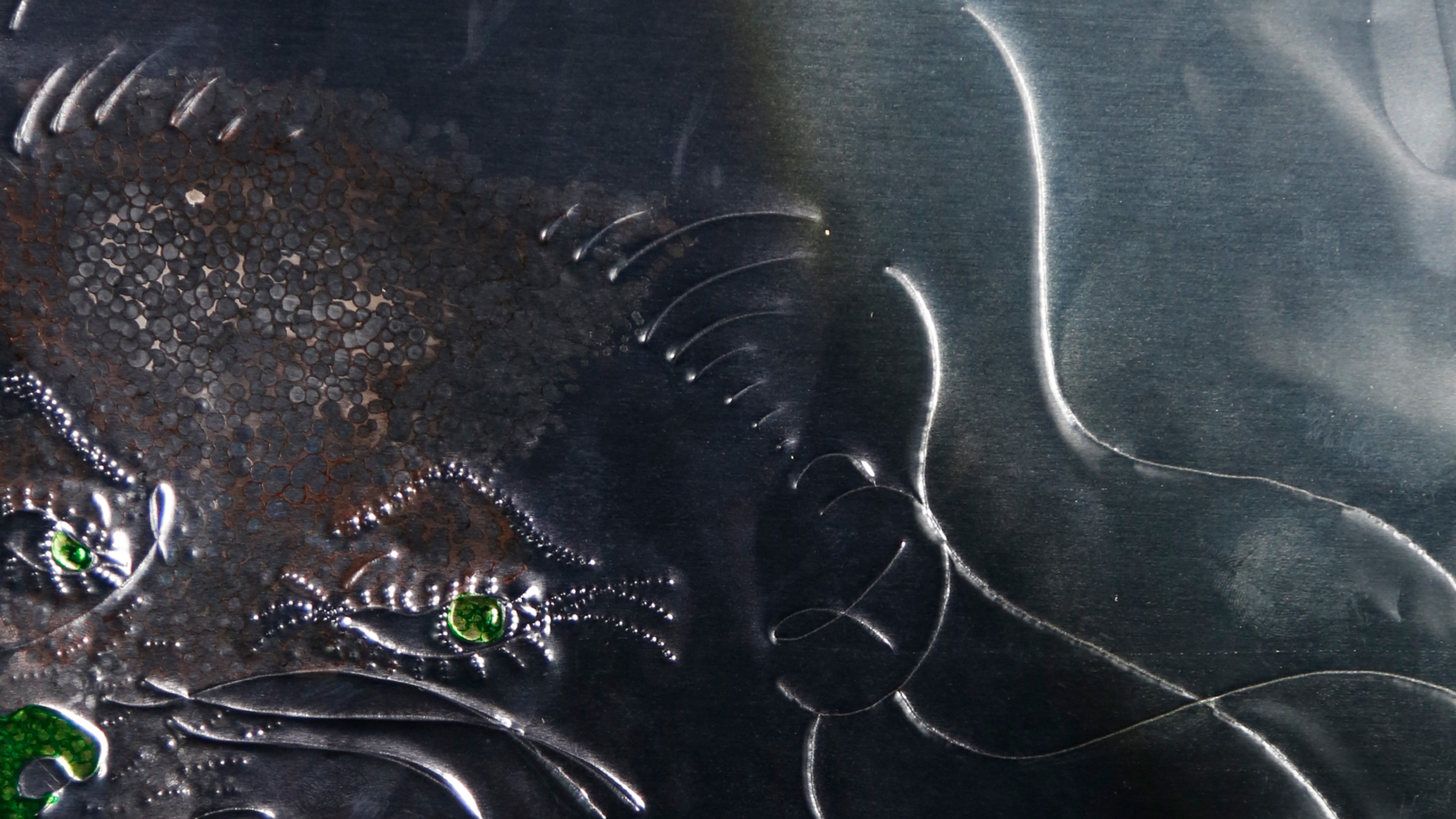 A silver surface with green protrusions.