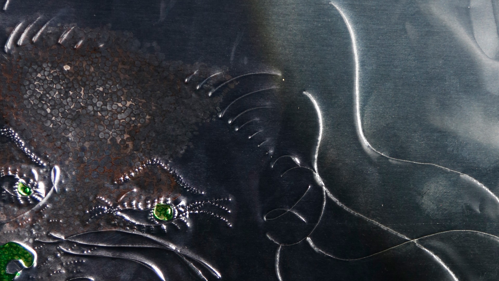 A silver surface with green protrusions.