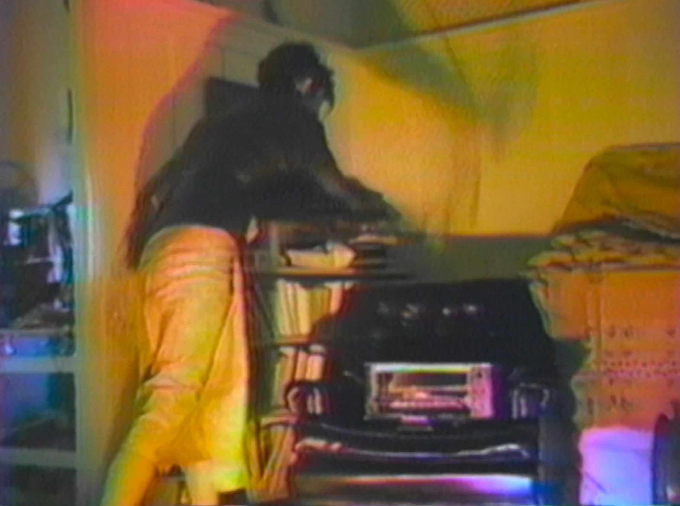 A person stands next to a chair with a microwave.
