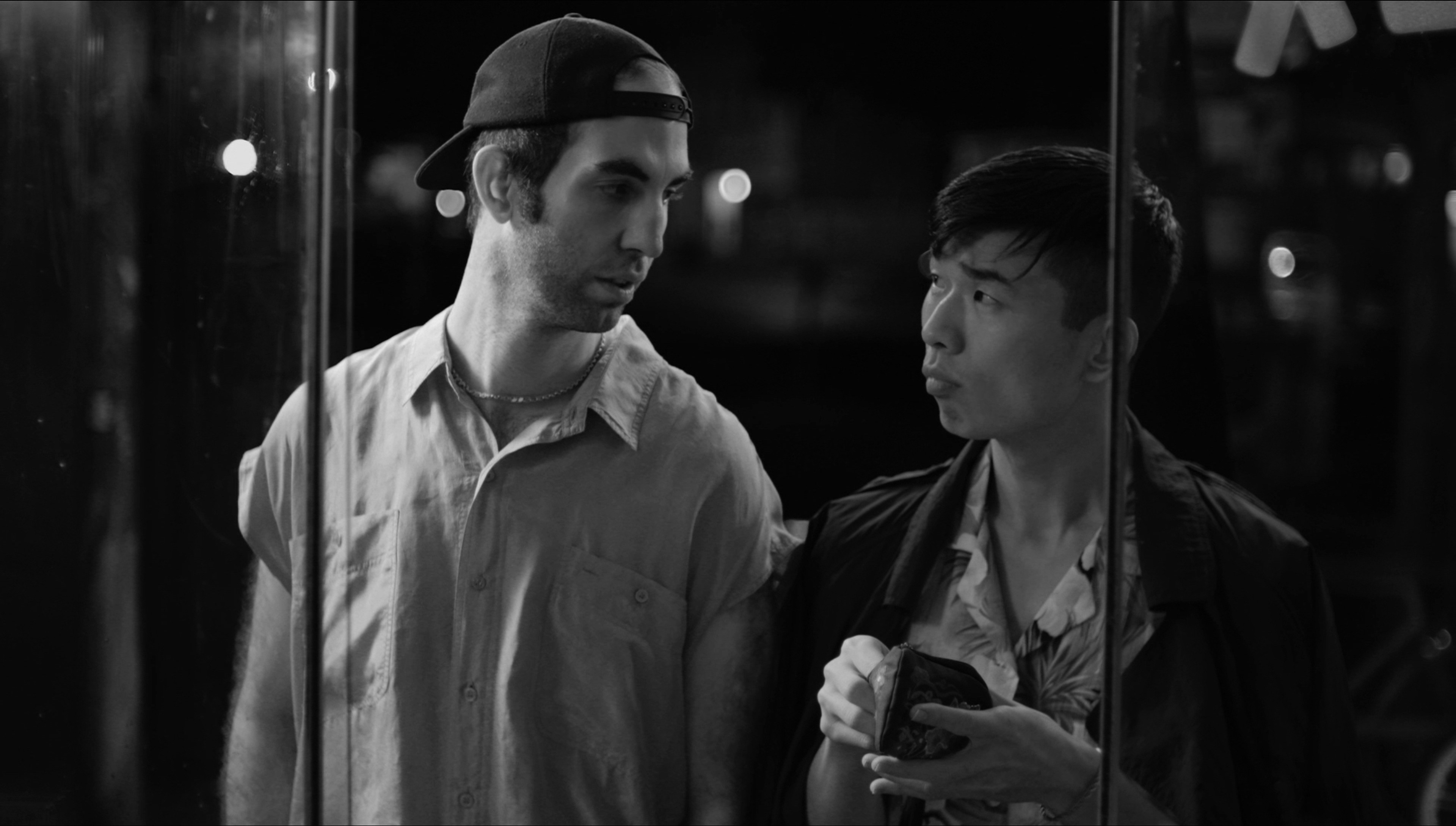 Two men stand next to each other.