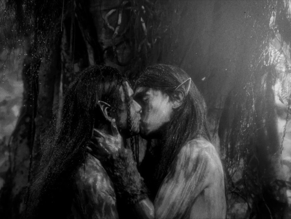 Two figures with pointy ears embrace.