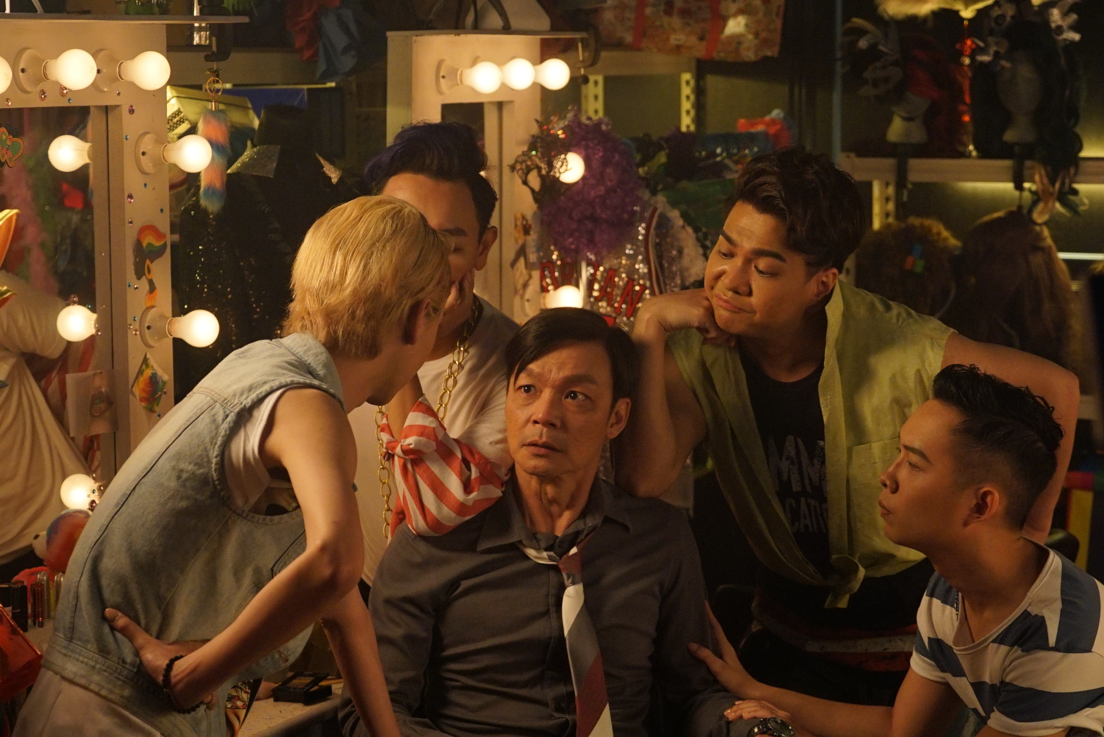 A person in a striped tie surrounded by four other people.