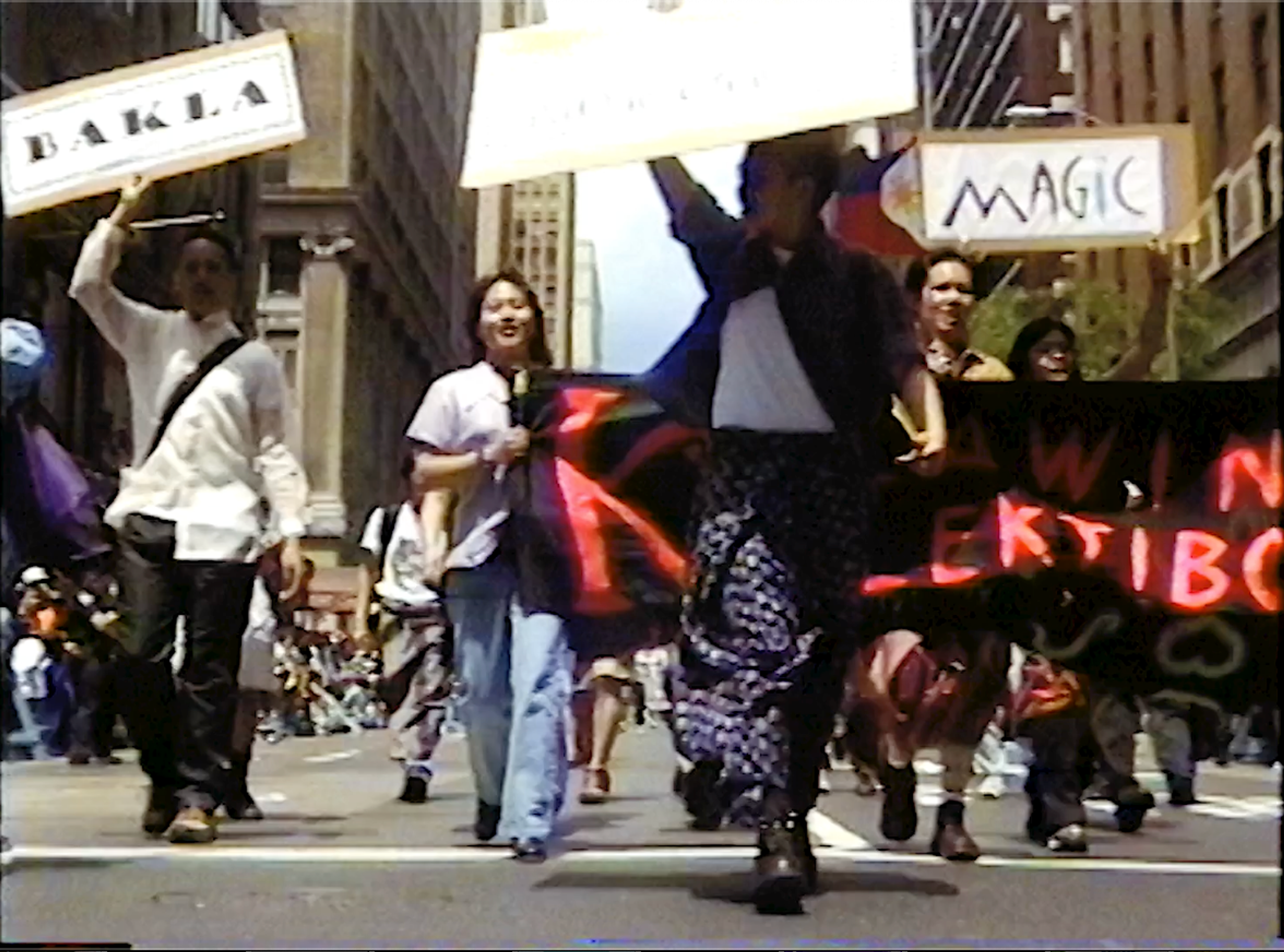 people hold up signs at a protest.