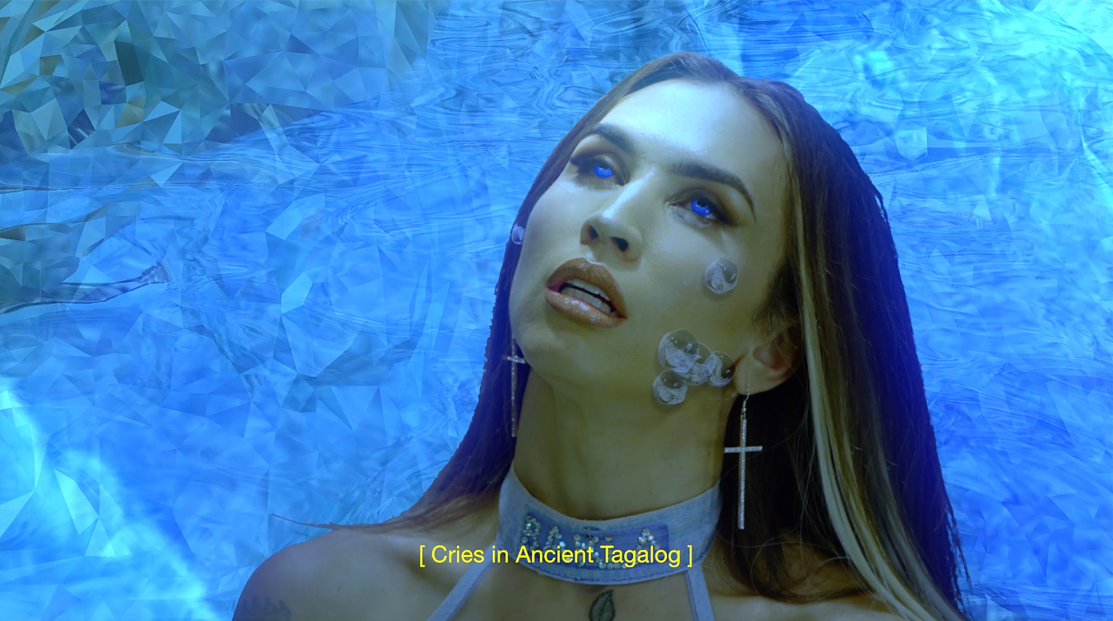 A digital figure standing in a surreal blue virtual landscape, surrounded by floating face-like forms and fantastical objects.