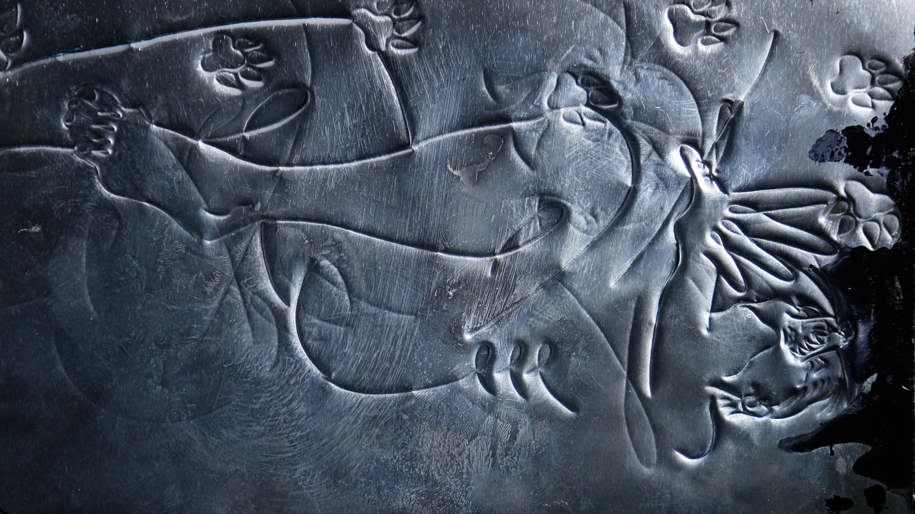 A silver surface with engravings