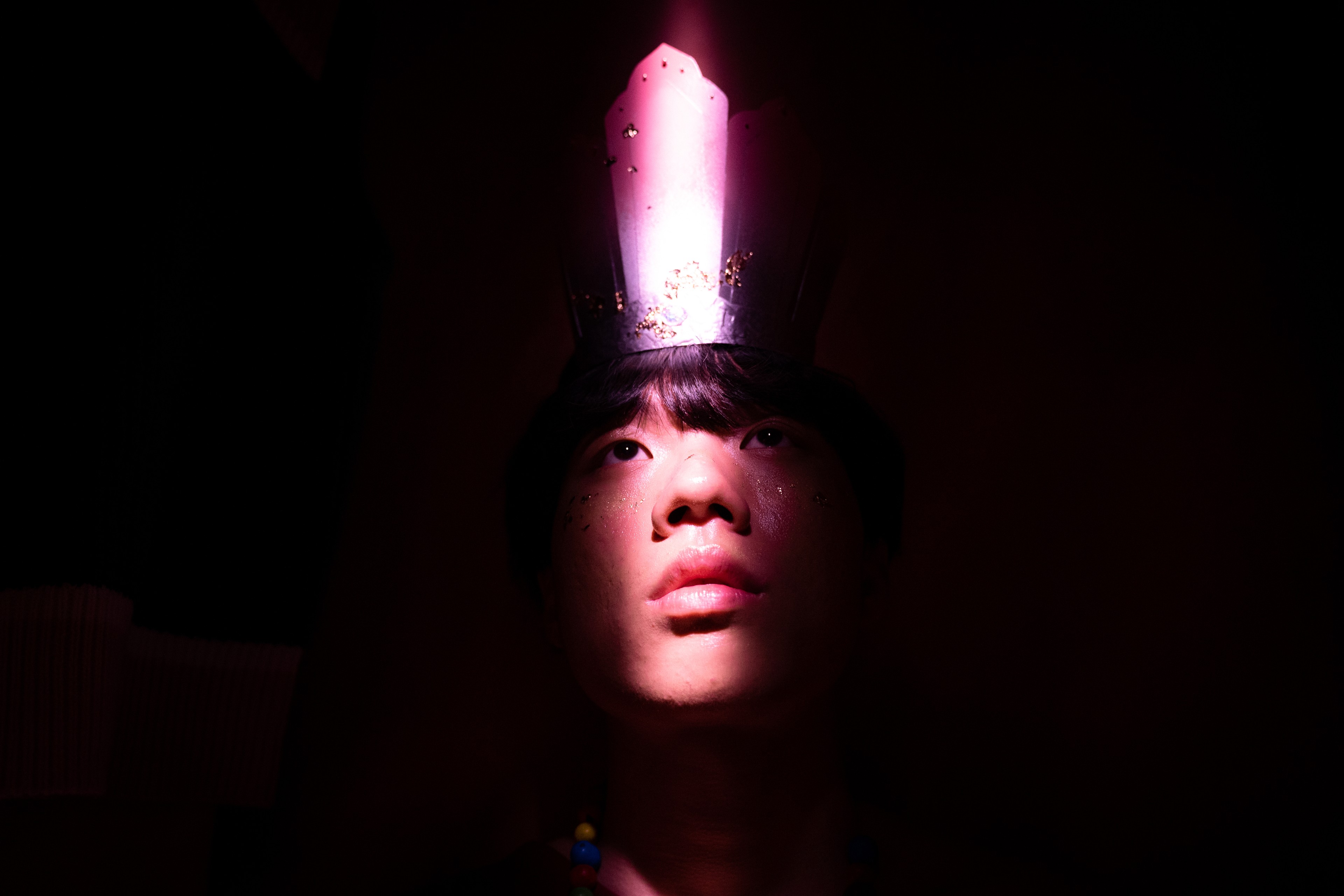 A boy wearing a crown 