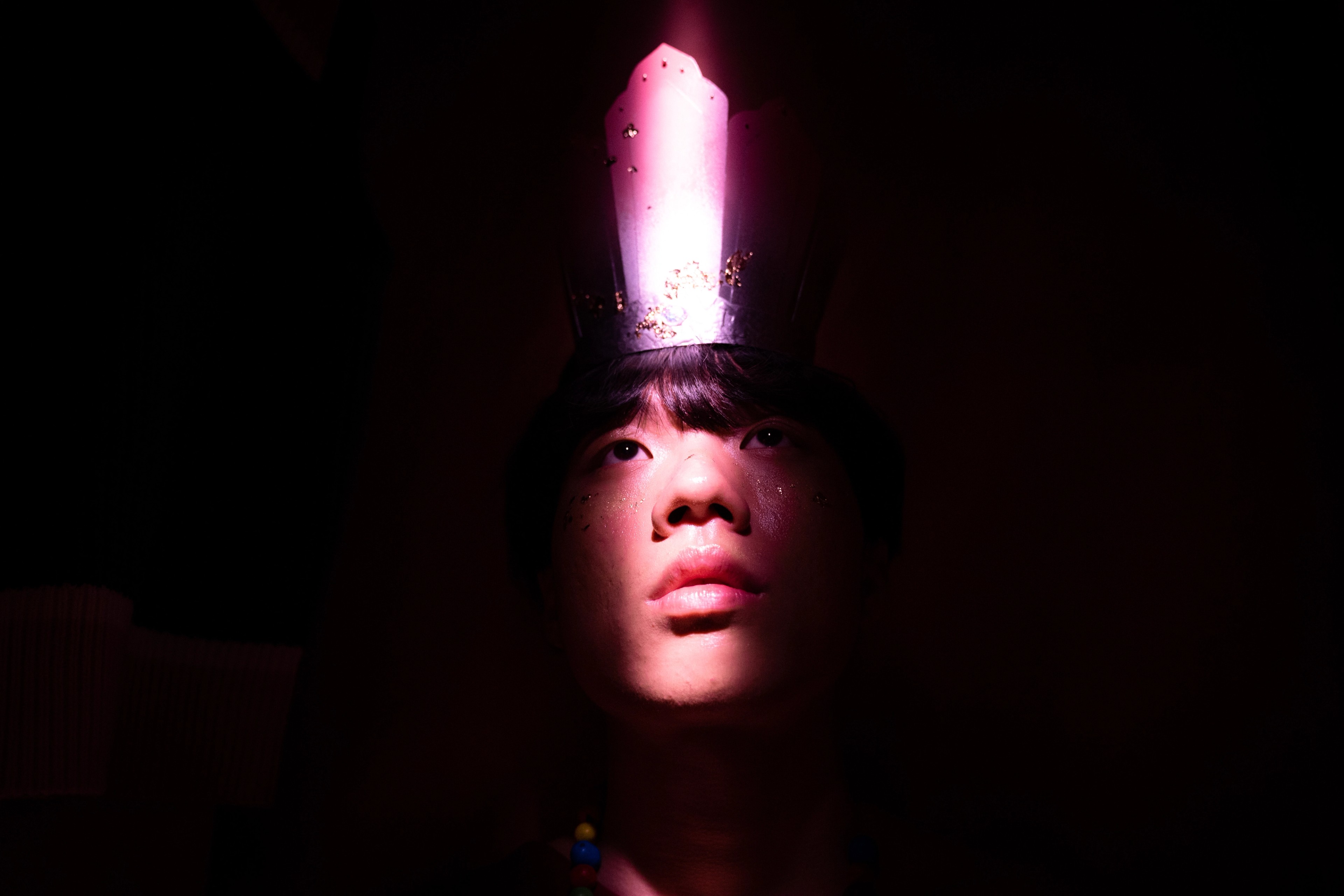 A boy wearing a crown