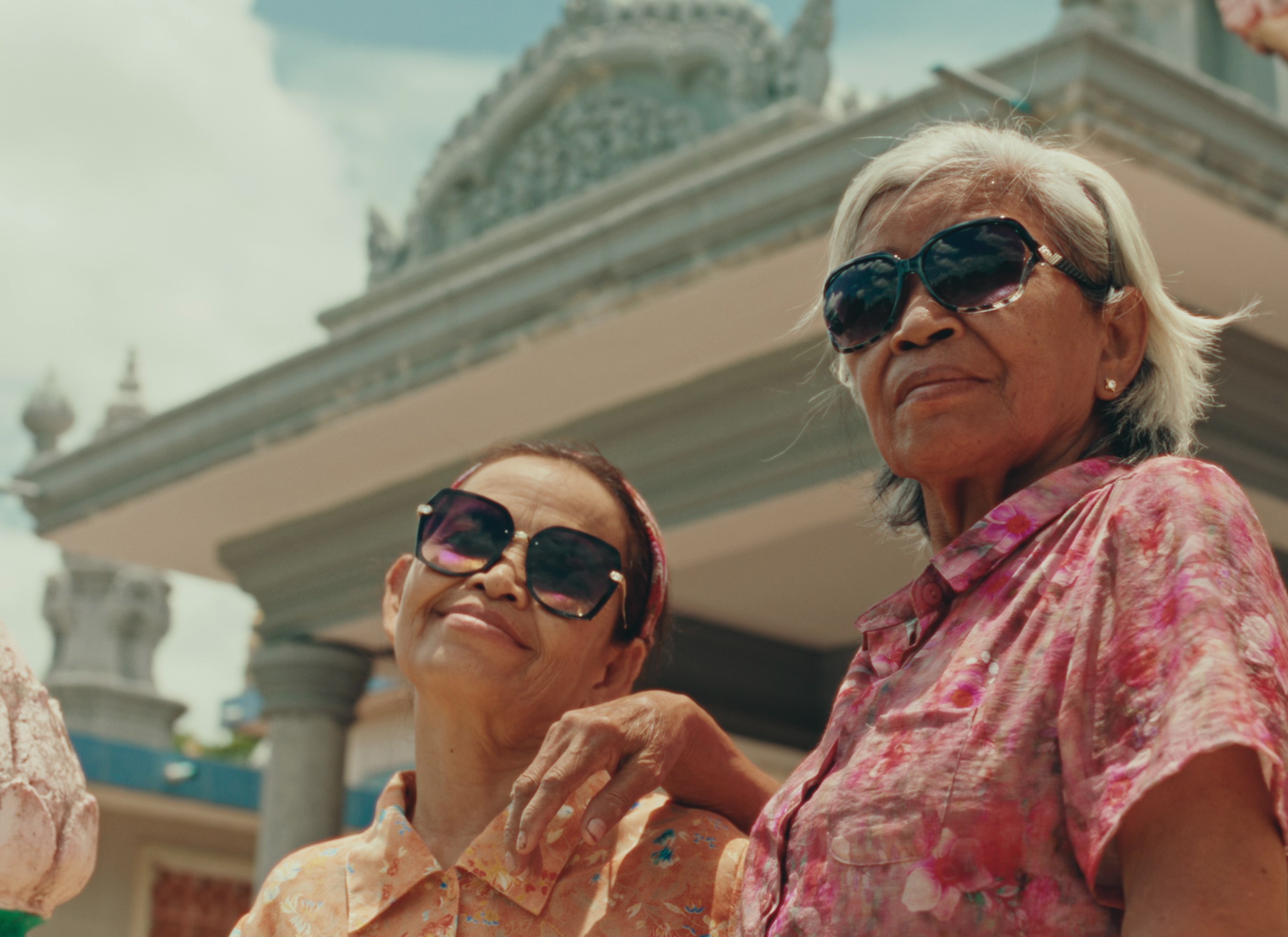 Two old women wearing sunglasses.