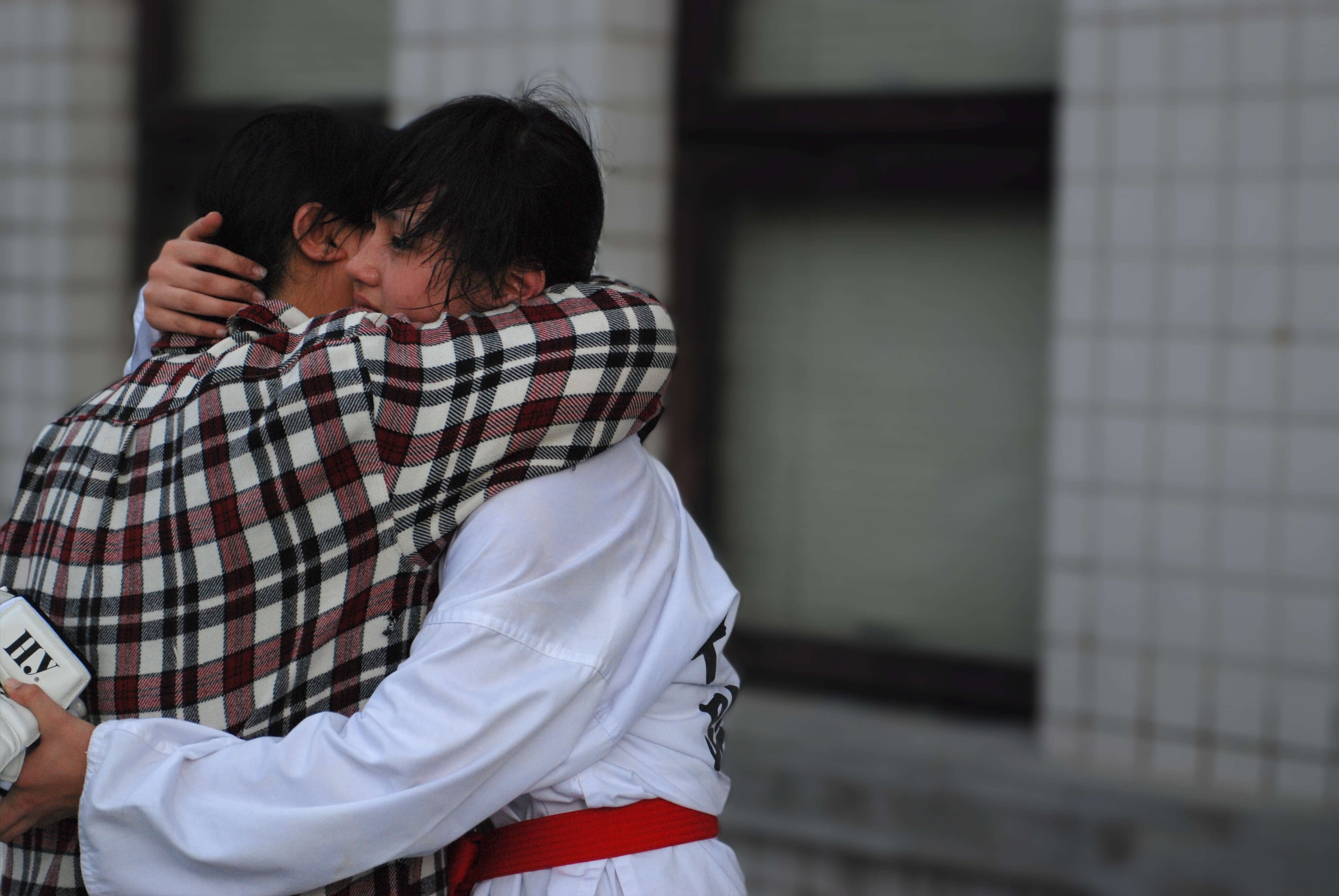 Two girls embrace.