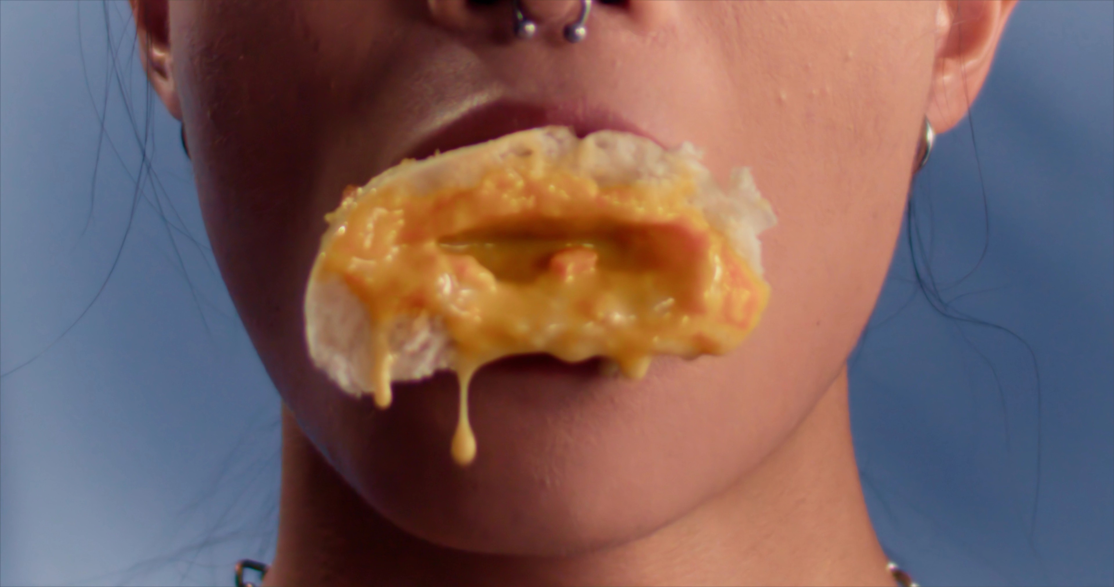 a mouth with a dripping custard bun