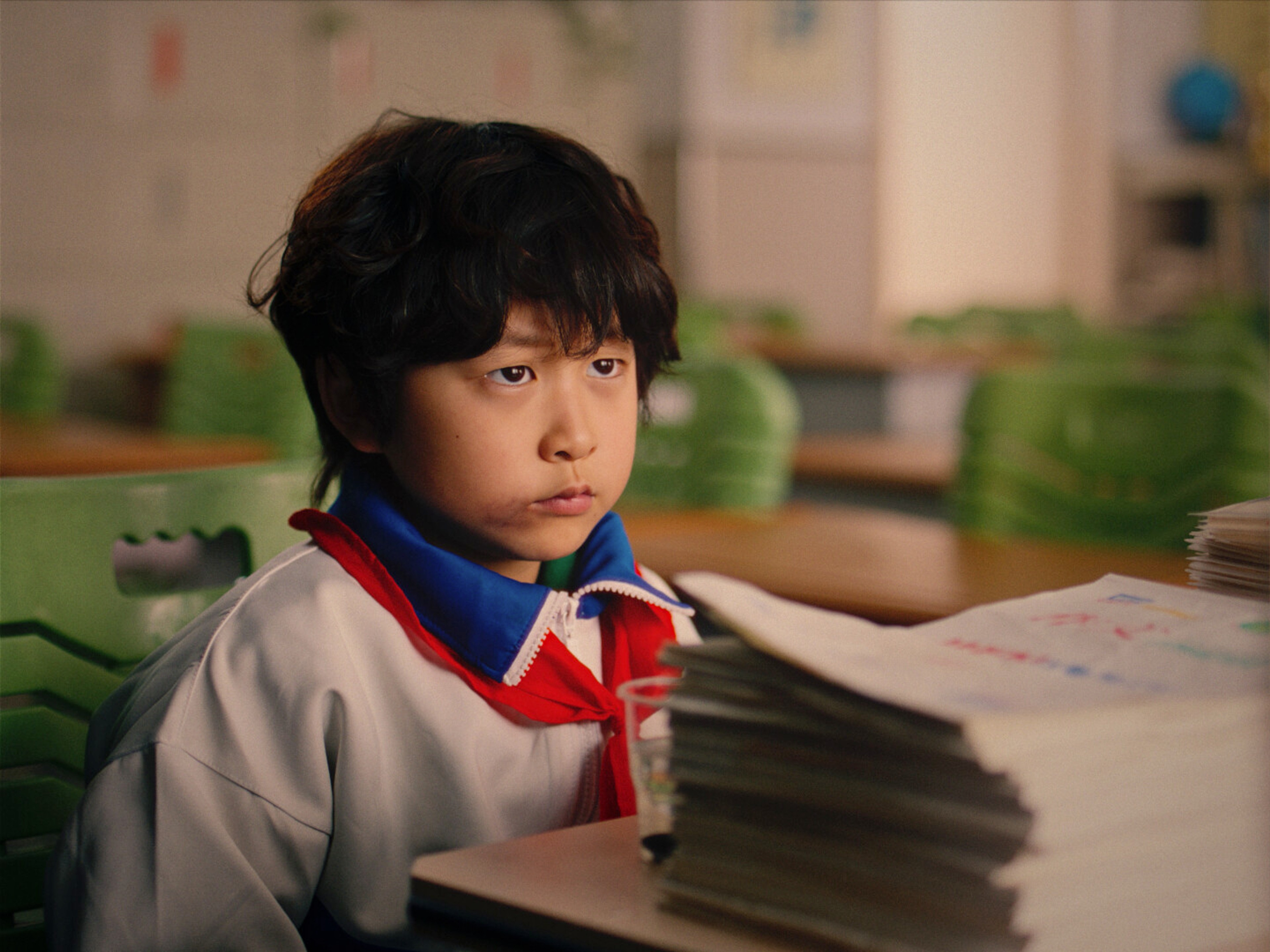 a young boy wearing school uniform.