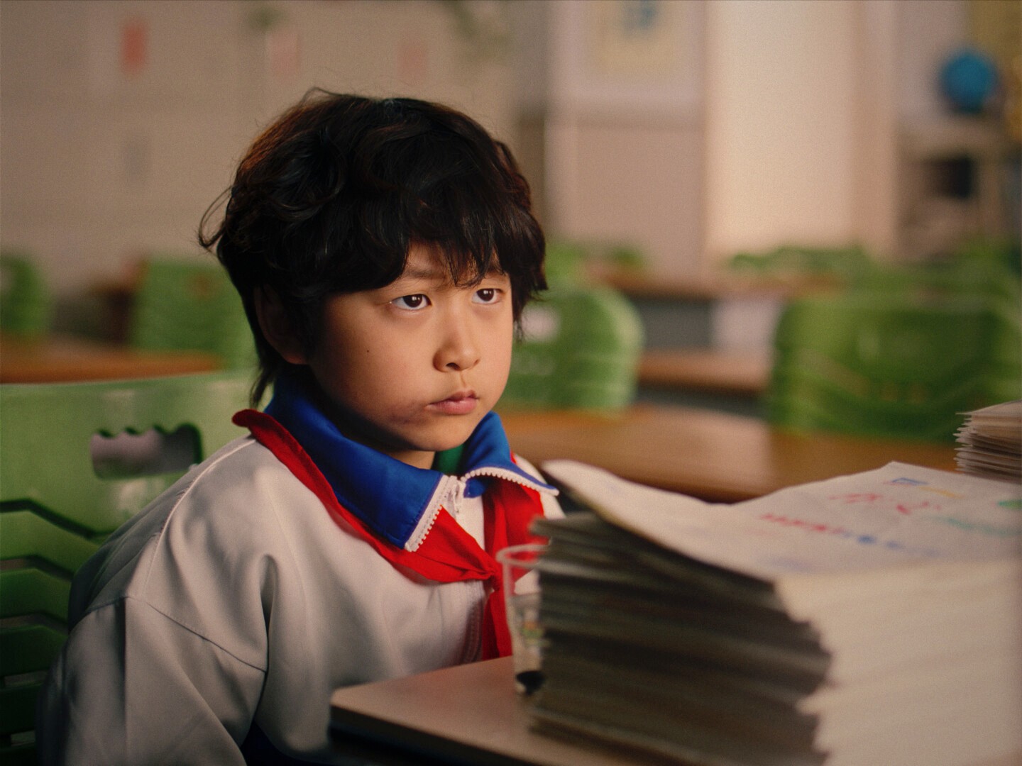 a young boy wearing school uniform.